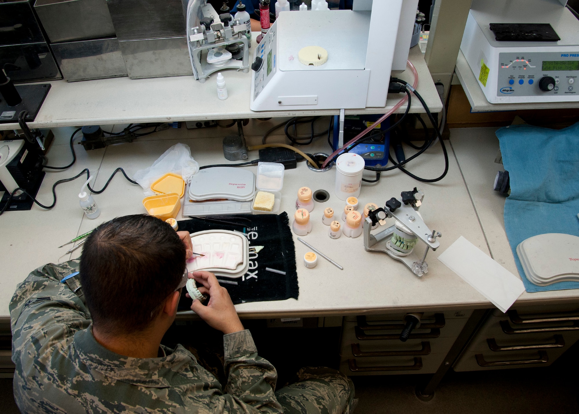 PETERSON AIR FORCE BASE, Colo. – Senior Airman Jonathon Stambaugh, 21st Dental Squadron dental lab technician, works on creating porcelain teeth at the Area Dental Lab, April 8, 2015. The ADL is one of three Department of Defense labs that provide fixed dental works along with removable dental works and services Department of Defense bases around the world. The other two ADLs are in Ramstein AB, Germany, and Kadena AB, Japan. (U.S. Air Force photo by Senior Airman Tiffany DeNault)