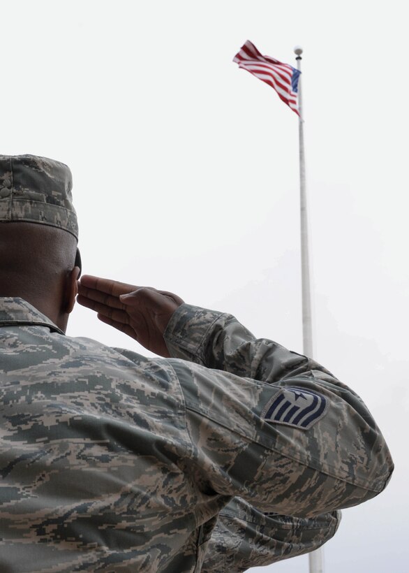 Tech. Sgt. Courtney Salmon, 28th Maintenance Group unit training manager, salutes the flag during a retreat ceremony at Ellsworth Air Force Base, S.D., April 17, 2015. Retreat signals the end of the duty day and serves as a time to pay respect to the flag. (U.S. Air Force photo by Airman 1st Class Rebecca Imwalle / Released)