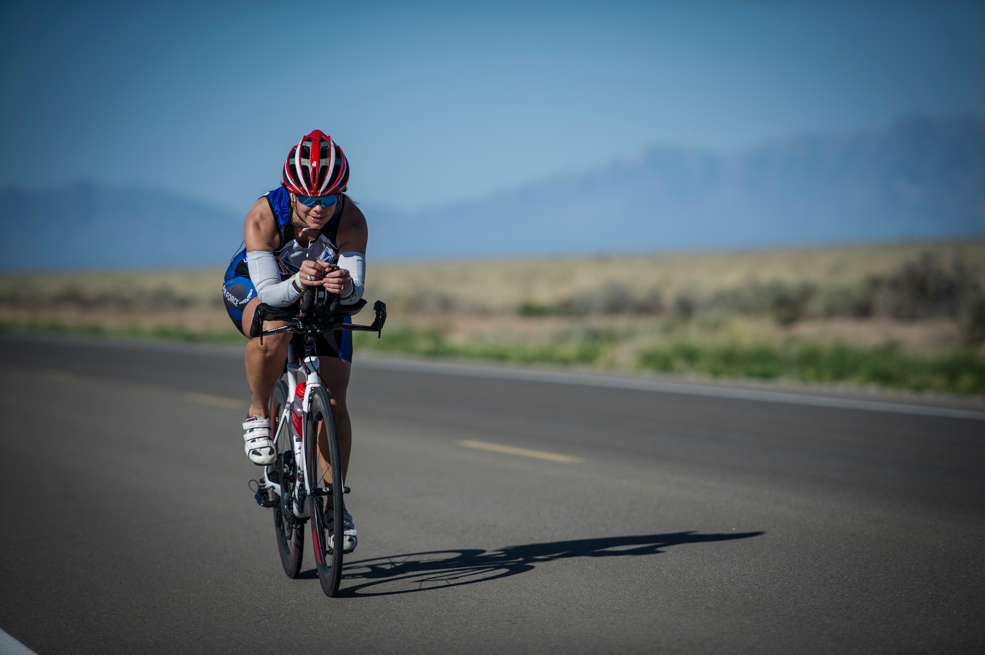 Colonel Leslie Knight, 49th Medical Group commander, nears the halfway point of the 30k bike ride portion of the Joker Duathlon, which was held at Holloman Air Force base, N.M., April 25, 2015. Knight and other members of Team Holloman gathered to participate in a marathon consisting of a 5k run, 30k bike ride and an additional 3k run to complete the marathon. The 49th Force Support Squadron routinely holds sporting events and marathons throughout the year for base personnel and their families to compete get some exercise and have fun. (U.S. Air Force photo by Airman 1st Class Aaron Montoya / Released)