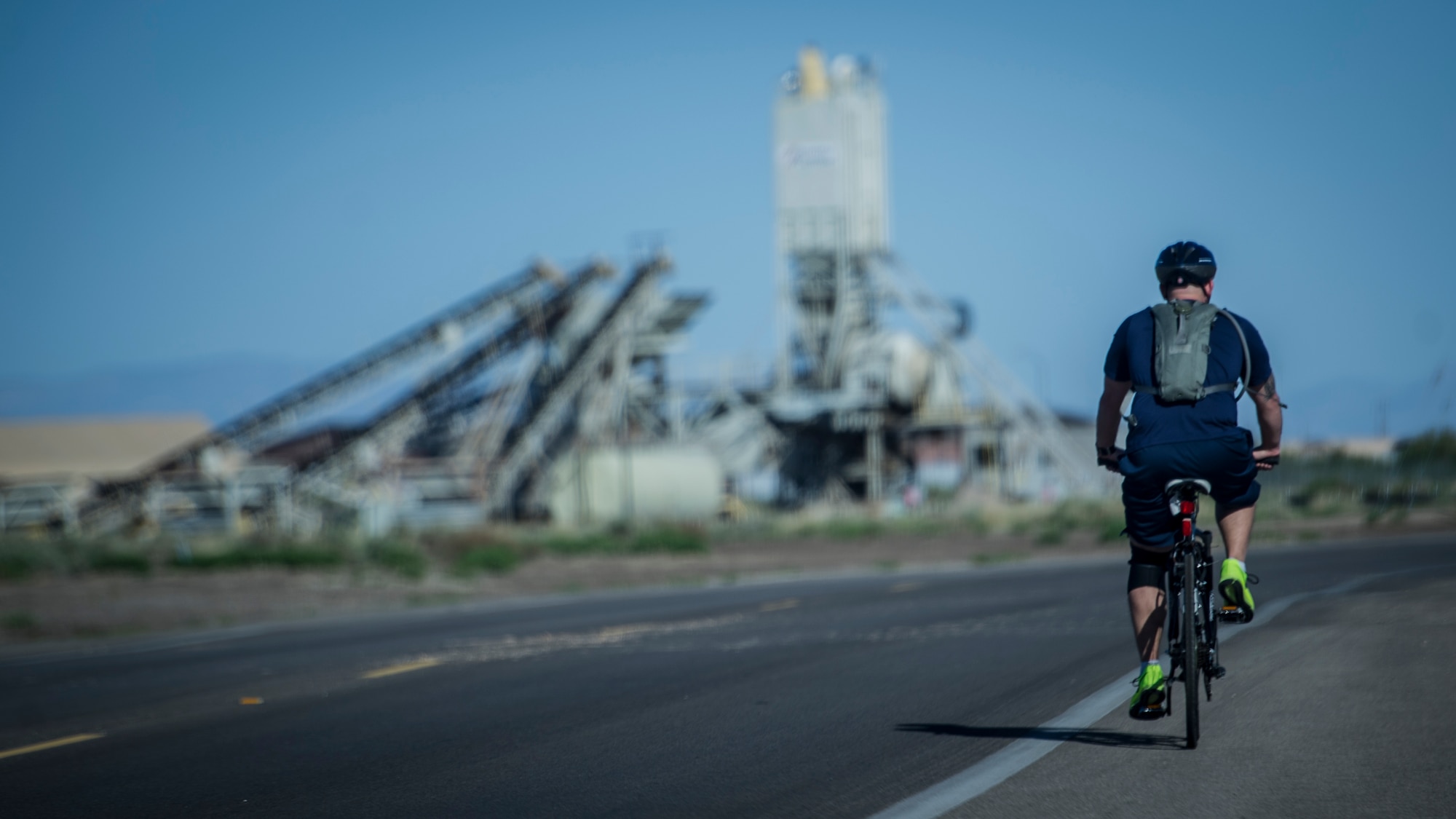 A member of Team Holloman bikes his way around the base perimeter road during the 30k bike ride portion of the Joker Duathlon held at Holloman Air Force Base, N.M., April 25, 2015. The 49th Force Support Squadron and the Domenici Fitness Center hosted the duathlon that consisted of a 5k run, 30k bike ride and ended with an additional 3k run. Participants were allowed to join alone, or they could tackle the duathlon as a team of two. (U.S. Air Force photo by Airman 1st Class Aaron Montoya / Released)