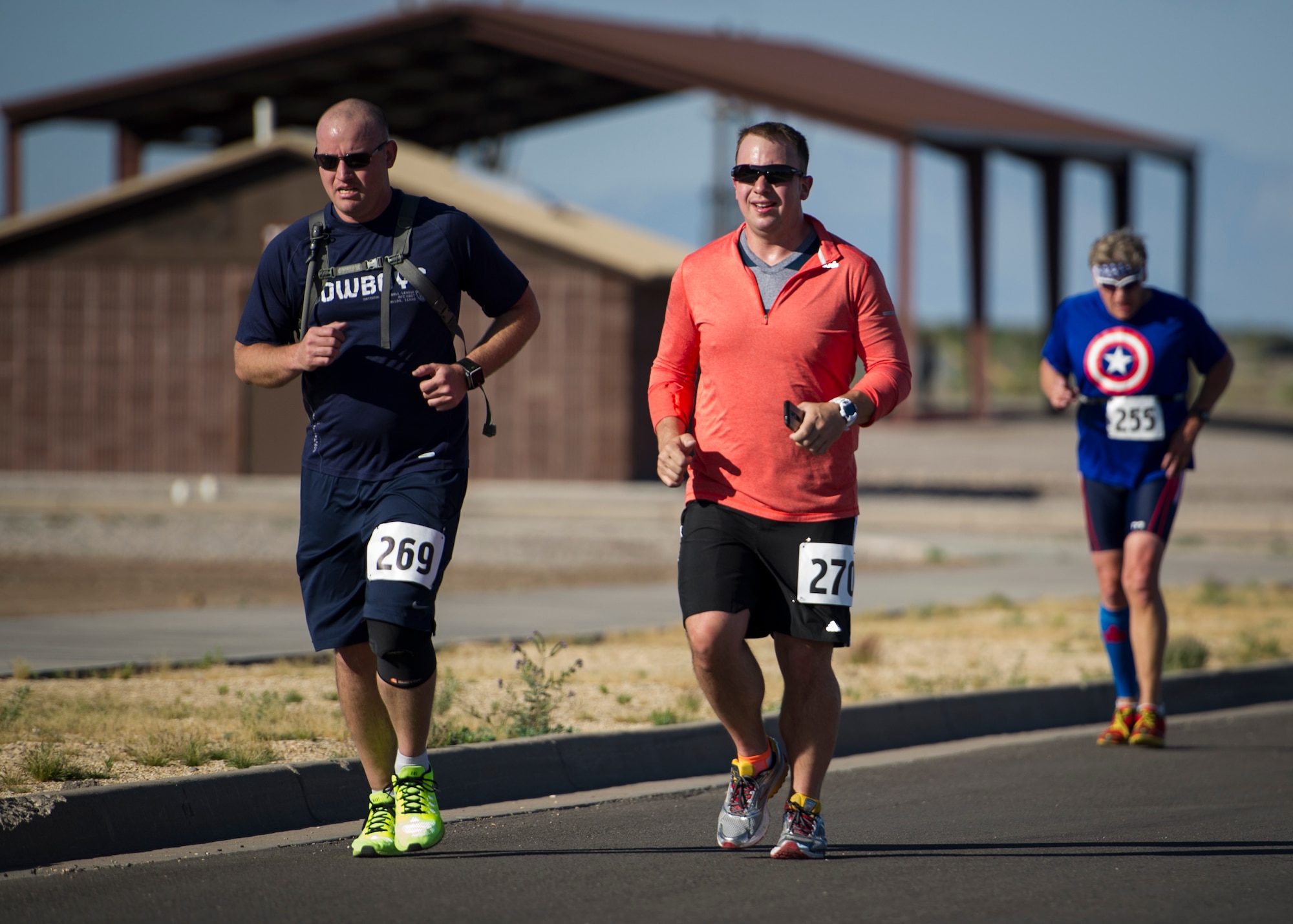 Participants of the Joker Duathlon near the finish line after the first leg of the event, a 5k run, before mounting their road bikes for a 30k ride, and a final 3k run at Holloman Air Force Base, N.M., April 25. The 49th Force Support Squadron and the Domenici Fitness Center were host to the durathlon and provided participants with a safety briefing, course medics and multiple water stations along their run and bike paths. (U.S. Air Force photo by Airman 1st Class Aaron Montoya / Released)