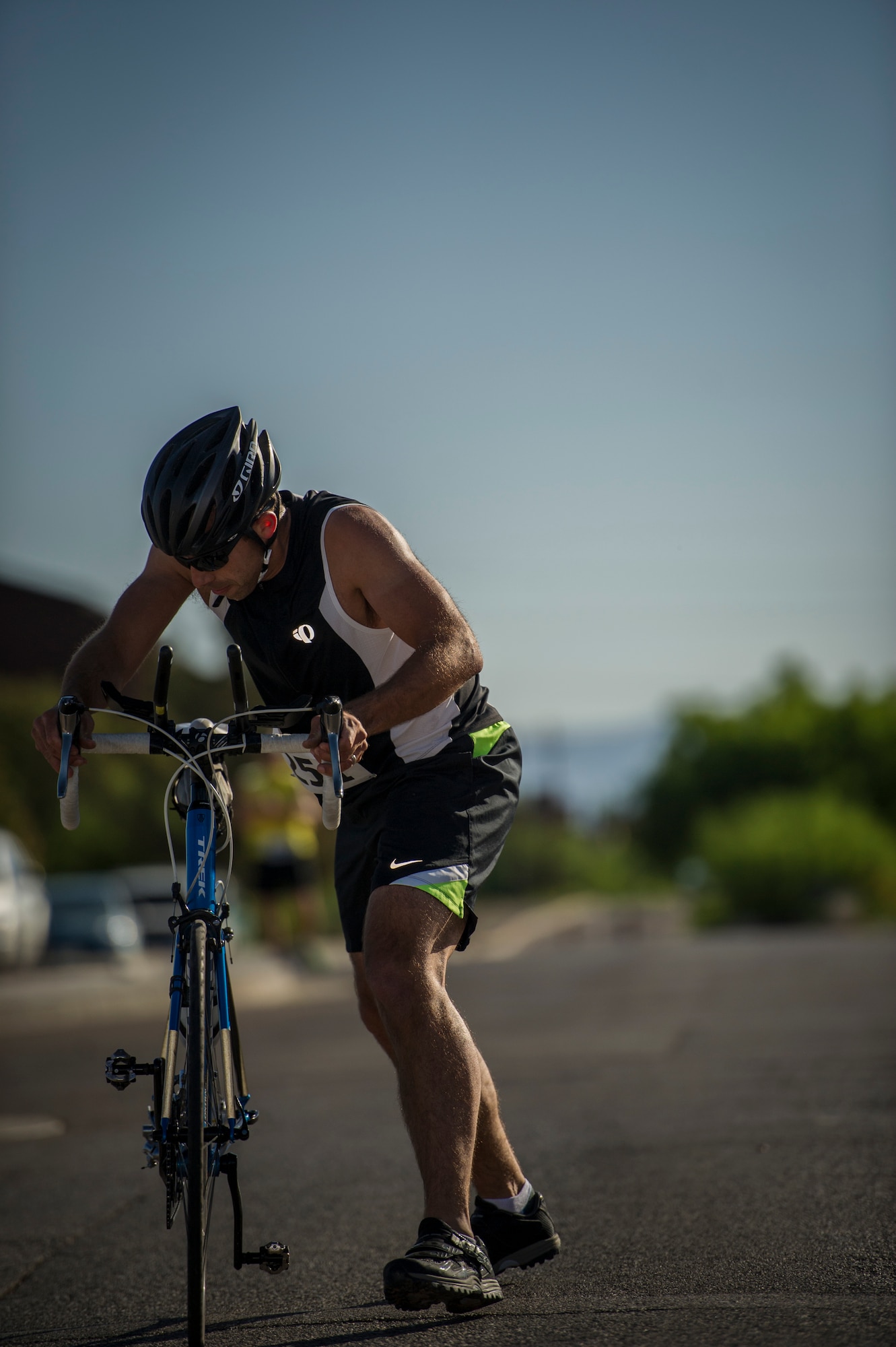 A participant in the Joker Duathlon prepares to mount his bike for the 30k road bike portion of the duathlon at Holloman Air Force Base, N.M., April 25, 2015. The 49th Force Support Squadron and the Domenici Fitness Center teamed up to offer Holloman personnel the opportunity to participate in a duathlon which consisted of a 5k run, 30k bike ride and finished with another 3k run. (U.S. Air Force photo by Airman 1st Class Aaron Montoya / Released)