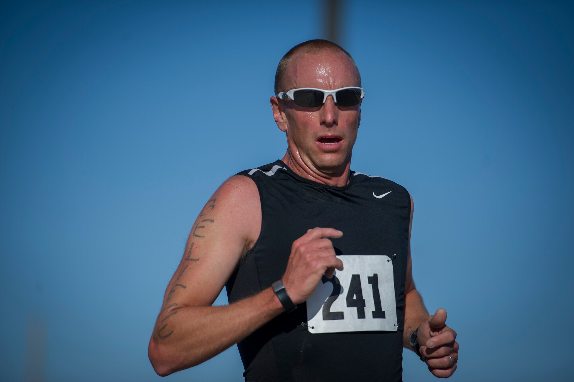 A participant in the Joker Duathlon nears the finish of the marathon at Holloman Air Force Base, N.M., April 25, 2015. The 49th Force Support Squadron and the Domenici Fitness Center hosted a duathlon that consisted of a 5k run, 30k bike ride and ended with an additional 3k run. The 49th Force Support Squadron routinely holds sporting events and marathons throughout the year for base personnel and their families to compete get some exercise and have fun. (U.S. Air Force photo by Airman 1st Class Aaron Montoya / Released)
