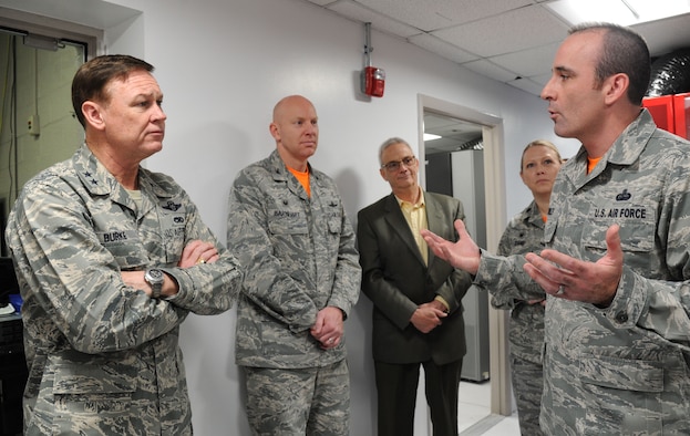 Master Sgt. Justin Worley explains the benefits of the Shared Computing Environment to Air Force District of Washington Commander Maj. Gen. Darryl Burke during a ribbon cutting ceremony for the space holding the SCE equipment at Joint Base Andrews, Md., April 24, 2015. The creation of the 844th Communication Group’s SCE establishes a stable and secure information technology environment in line with the Defense Department’s Joint Information Environment. Donaldson is a 744th Communications Squadron voice network engineer. (U.S. Air Force photo/Master Sgt. Tammie Moore)