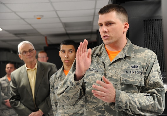 Tech. Sgt. Robert Donaldson III explains the benefits of the Shared Computing Environment during a ribbon cutting ceremony for the space holding the SCE equipment at Joint Base Andrews, Md., April 24, 2015. The creation of the 844th Communication Group’s SCE establishes a stable and secure information technology environment in line with the Defense Department’s Joint Information Environment. Donaldson is the 844th CG configuration manager. (U.S. Air Force photo/Master Sgt. Tammie Moore)