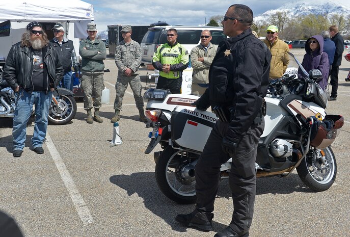 Sgt. Donavan Lucas, of the Utah Highway Patrol, briefs Motorcycle Rodeo participants April 16 about the differences in riding style between state troopers and recreational riders. The Green Knights motorcycle club hosted the event to encourage Hill Air Force Base motorcycle riders to be safe. (ALEX R. LLOYD/U.S. Air Force)