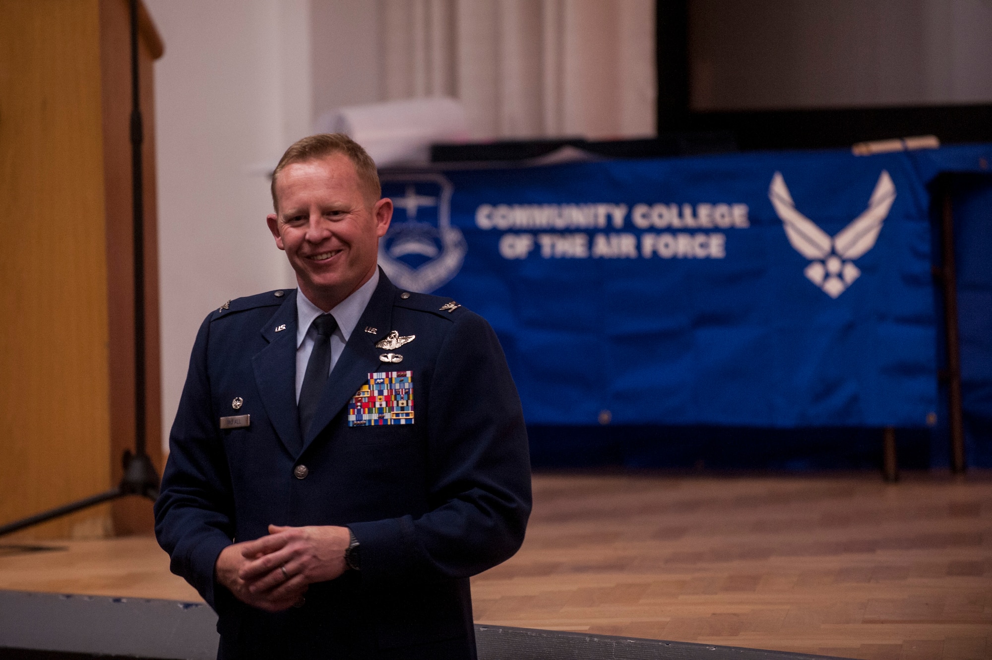 U.S. Air Force Col. Joe McFall, 52nd Fighter Wing commander, smiles during his closing remarks of a Community College of the Air Force graduation ceremony at the base theater April 24, 2015, at Spangdahlem Air Base, Germany. McFall along with other wing senior leaders congratulated the graduates on reaching an important career milestone. (U.S. Air Force photo by Senior Airman Rusty Frank/Released)