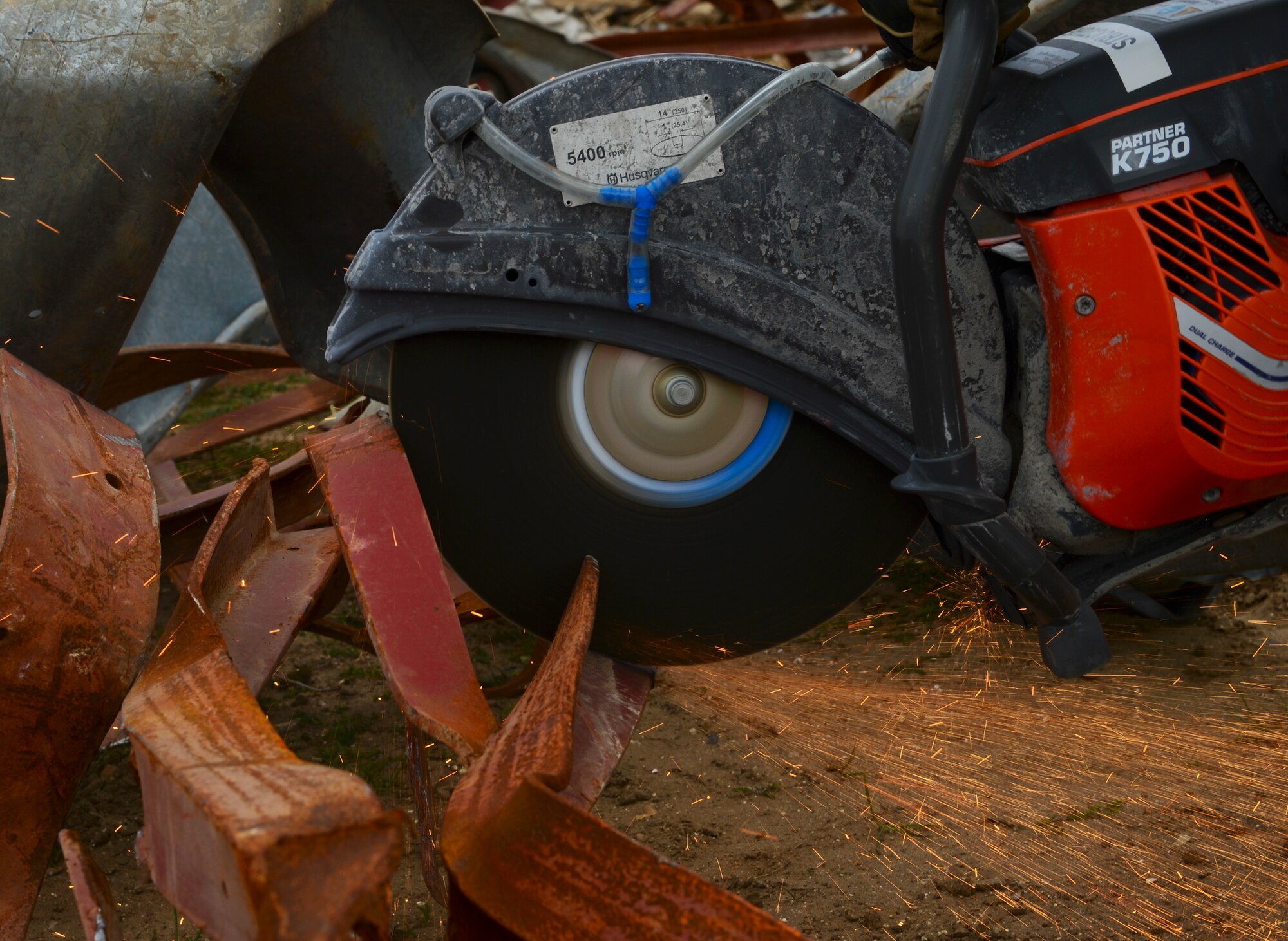 Airmen from the 48th Civil Engineer Squadron cut through metal at Royal Air Force Lakenheath, England, April 22, 2015. Nearly six tons of metal from the site were recycled by squadron Airmen. (U.S. Air Force photo by Airman 1st Class Dawn M. Weber/Released)