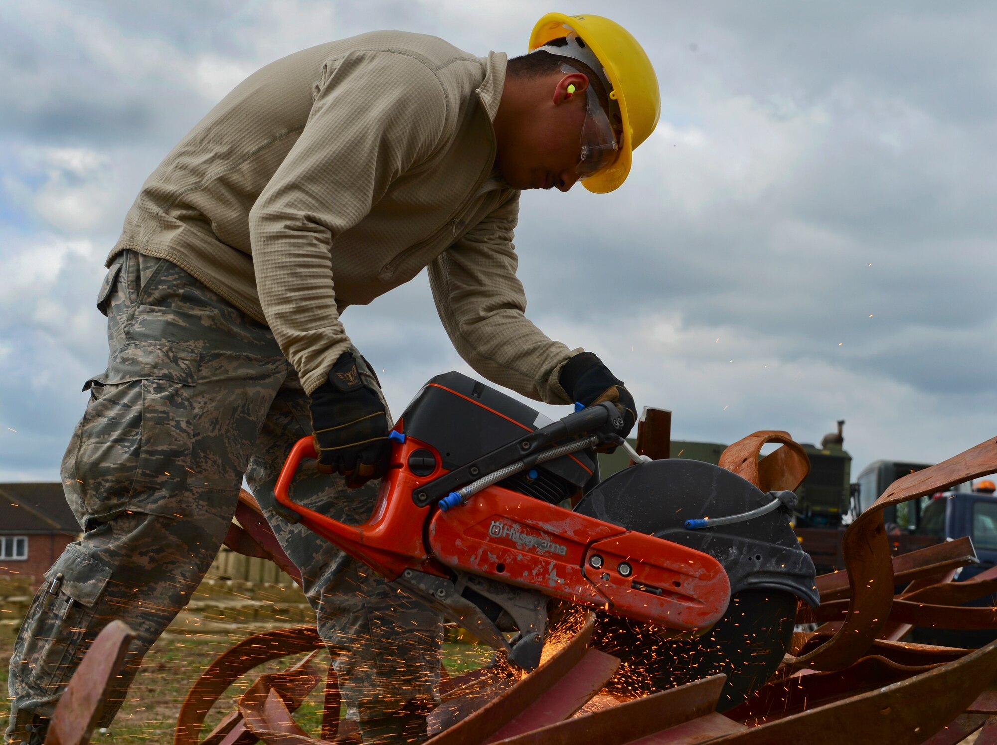 Airman Aaron Matedne, 48th Civil Engineer Squadron heavy equipment operator, cuts metal at Royal Air Force Lakenheath, England, April 22, 2015. After the metal is cut down, it’s disposed to the proper recycling facilities. This is just one of the many ways in which the 48th CES helps shape the installation. (U.S. Air Force photo by Airman 1st Class Dawn M. Weber/Released) 