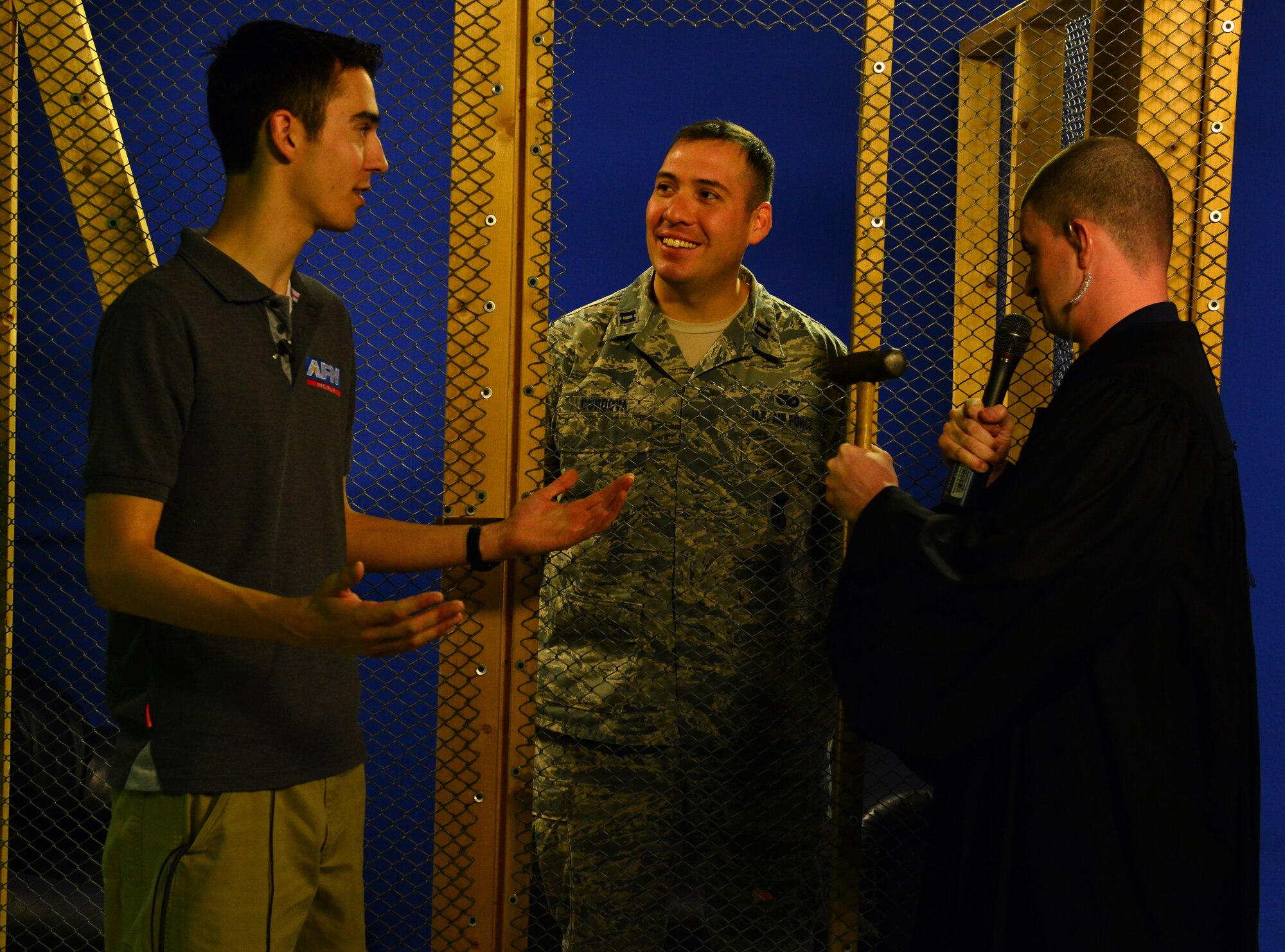 Senior Airman Scott Taylor, American Forces Network broadcaster, talks with Capt. Richard Cordova, 39th Security Forces Squadron officer in charge of plans and programs, while he serves his sentence in the “jail and bail” cell during the 2015 Air Force Assistance Fund Telethon April 23, 2015 at Incirlik Air Base, Turkey. The Air Force Assistance Fund was established as an annual effort to raise funds for the charitable affiliates that provide support to Air Force families in need. (U.S. Air Force photo by Senior Airman Michael Battles/Released)