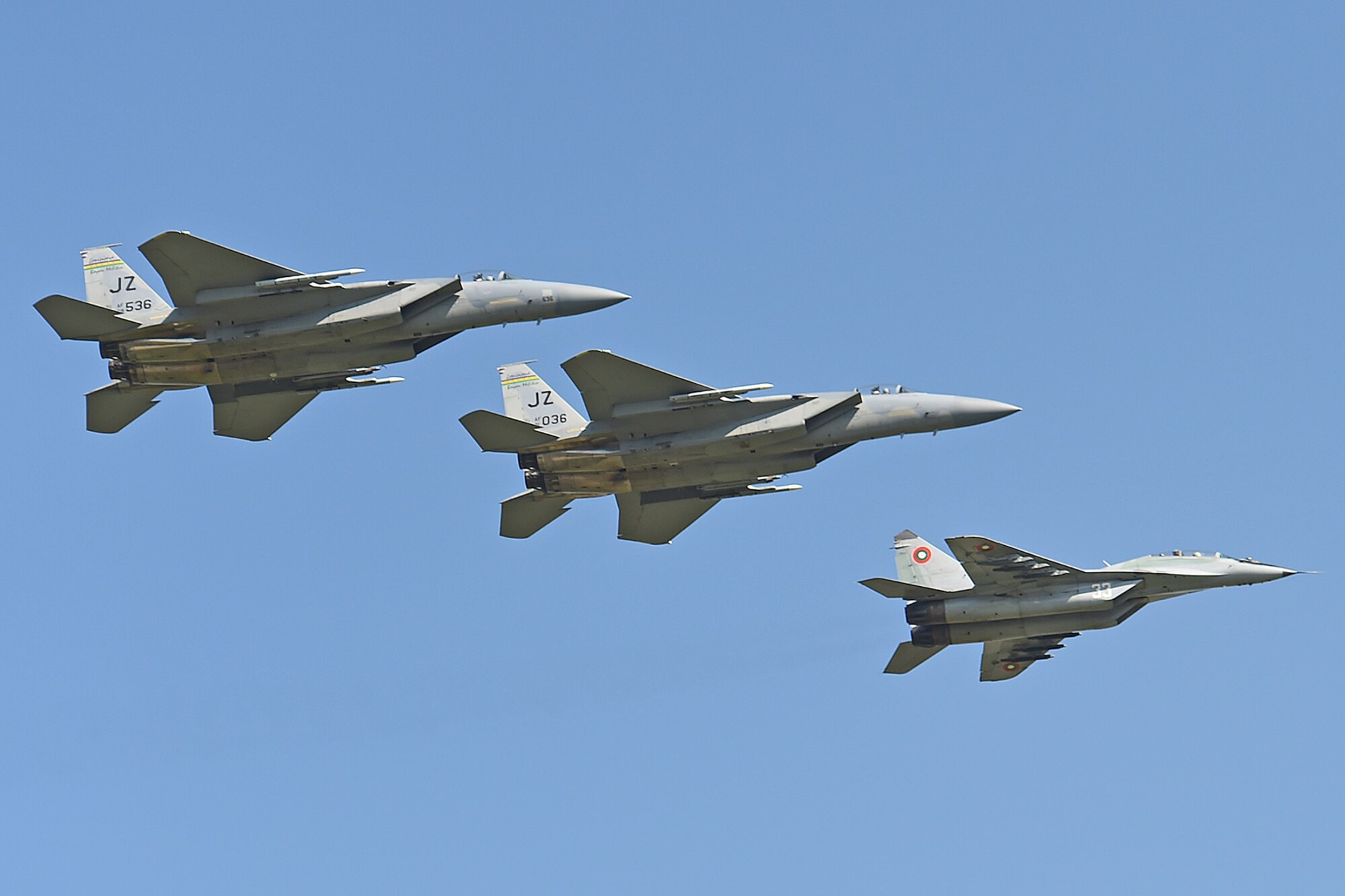 Two U.S. Air Force F-15 Eagles from the 159th Fighter Wing, Louisiana Air National Guard, fly in formation with a Bulgarian MiG-29 returning from a training mission to Graf Ignatievo Air Base, near Plovdiv, Bulgaria, April 23, 2015. The joint mission is designed to demonstrate the shared commitment and close cooperation with Bulgaria and all NATO allies on countering a range of regional and global threats. (U.S. Air National Guard photo by Master Sgt. Toby M. Valadie, 159th Public Affairs Office/RELEASED)
