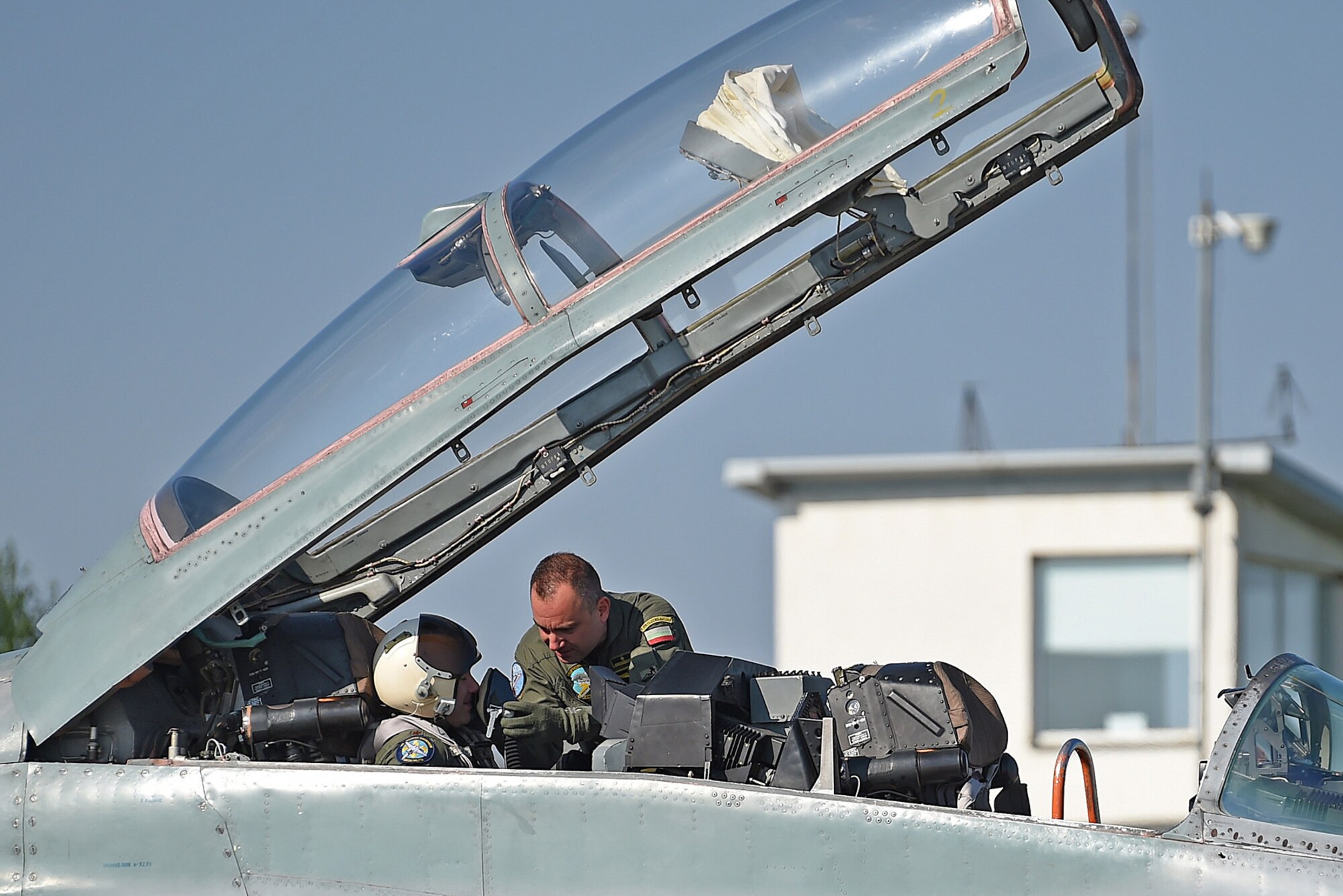 A Bulgarian MiG-29 pilot helps a Louisiana Air National Guard F-15 Eagle pilot attach his oxygen mask before a familiarization flight in a MiG-29 during a training mission at Graf Ignatievo Air Base, near Plovdiv, Bulgaria, April 20, 2015. Thracian Eagle 2015 is a bilateral exercise to enhance interoperability with Bulgaria and maintain joint readiness with NATO allies. (U.S. Air National Guard photo by Master Sgt. Toby M. Valadie, 159th Public Affairs Office/RELEASED)