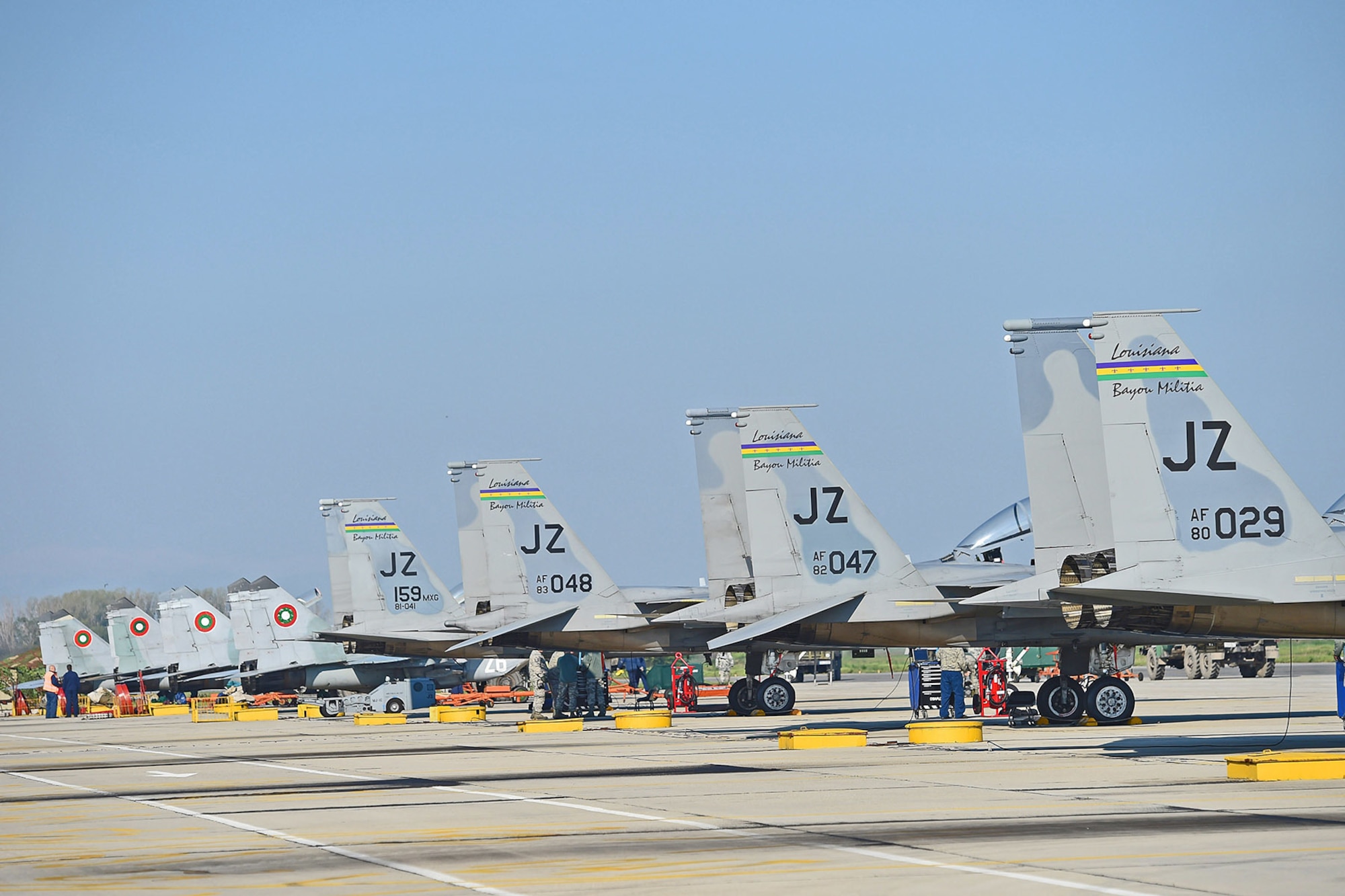 U.S. Air Force F-15 Eagles from the Louisiana Air National Guard???s 159th Fighter Wing and Bulgarian MiG-29s participating in Thracian Eagle 2015, a bilateral training exercise, are lined up at Graf Ignatievo Air Base, near Plovdiv, Bulgaria, April 20, 2015. The exercise allows U.S. and NATO to demonstrate their shared commitment to a peaceful, stable and secure Europe. (U.S. Air National Guard photo by Master Sgt. Toby M. Valadie, 159th Public Affairs Office/Released)