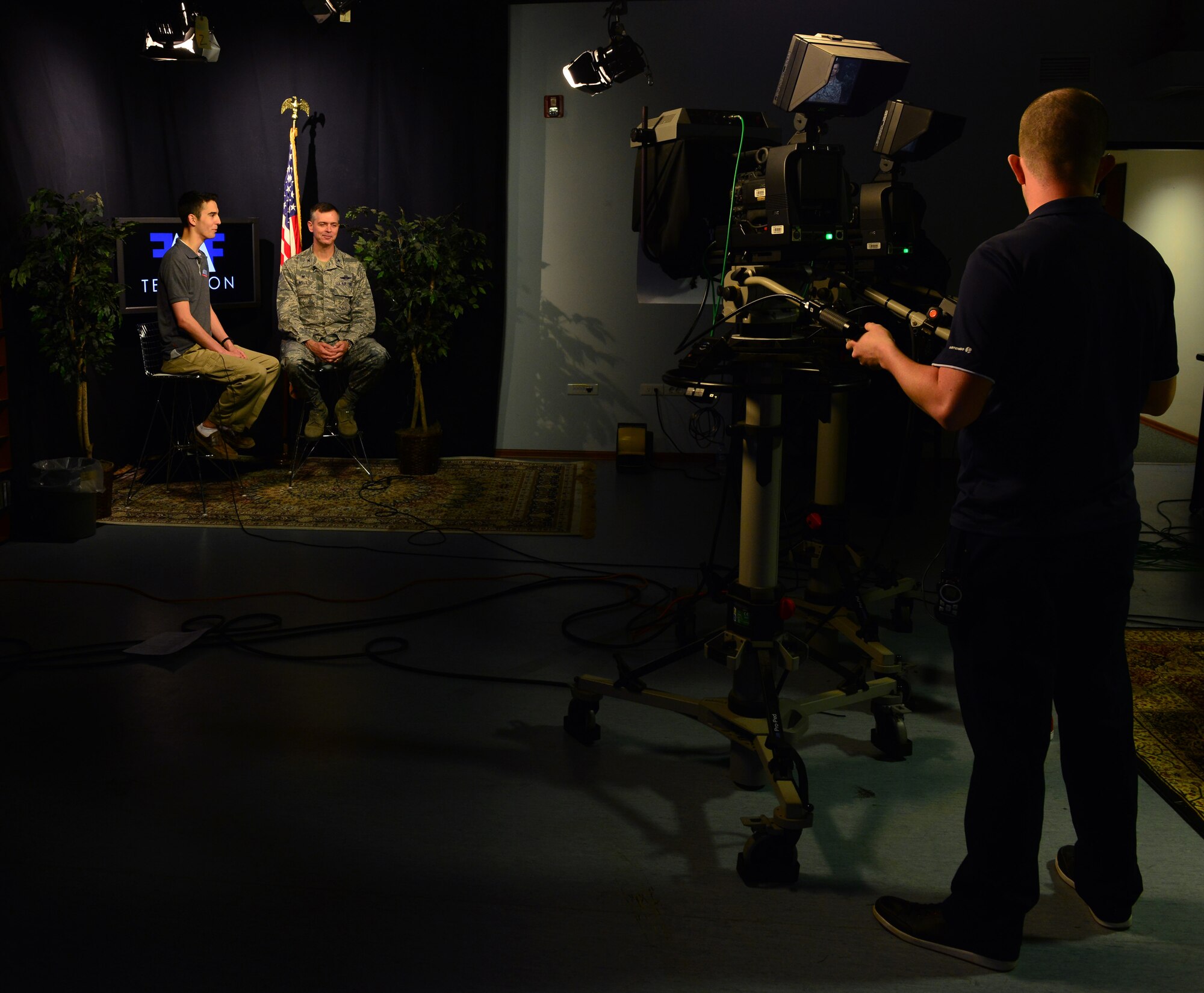Senior Airman Scott Taylor, American Forces Network broadcaster, interviews Col. Craig Wills, 39th Air Base Wing commander, during the 2015 Air Force Assistance Fund Telethon April 23, 2015, at Incirlik Air Base, Turkey. The purpose of the AFAF is to raise funds for the four charitable affiliates that support the Air Force family. (U.S. Air Force photo by Senior Airman Michael Battles/Released)