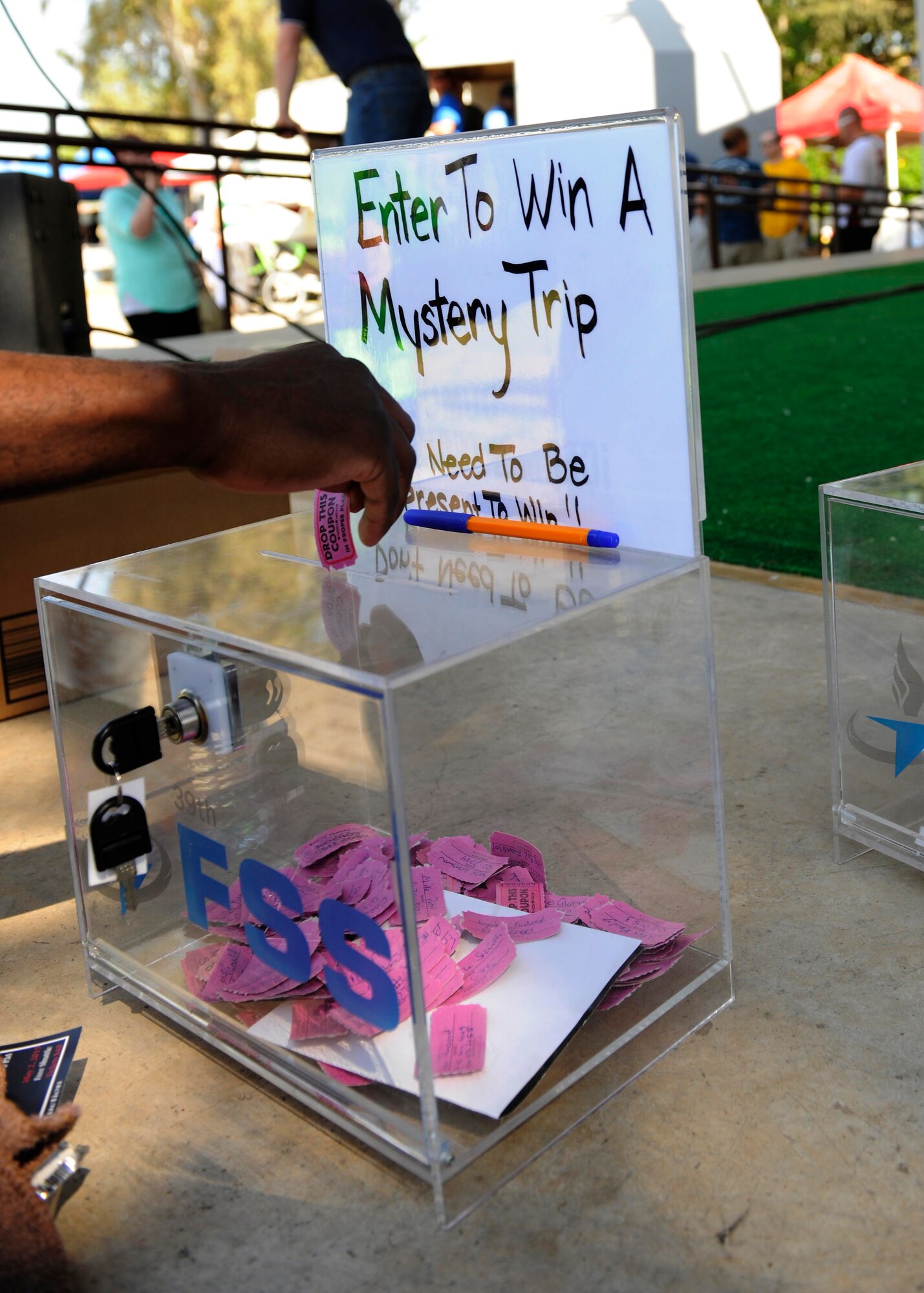 An attendee of the 2015 Spring Fling enters a raffle ticket to win a trip April 25, 2015, at Incirlik Air Base, Turkey. The annual event provided Airmen, their families, civilians and military partners a venue to come together in celebration of spring. (U.S. Air Force photo by Senior Airman Krystal Ardrey/Released)