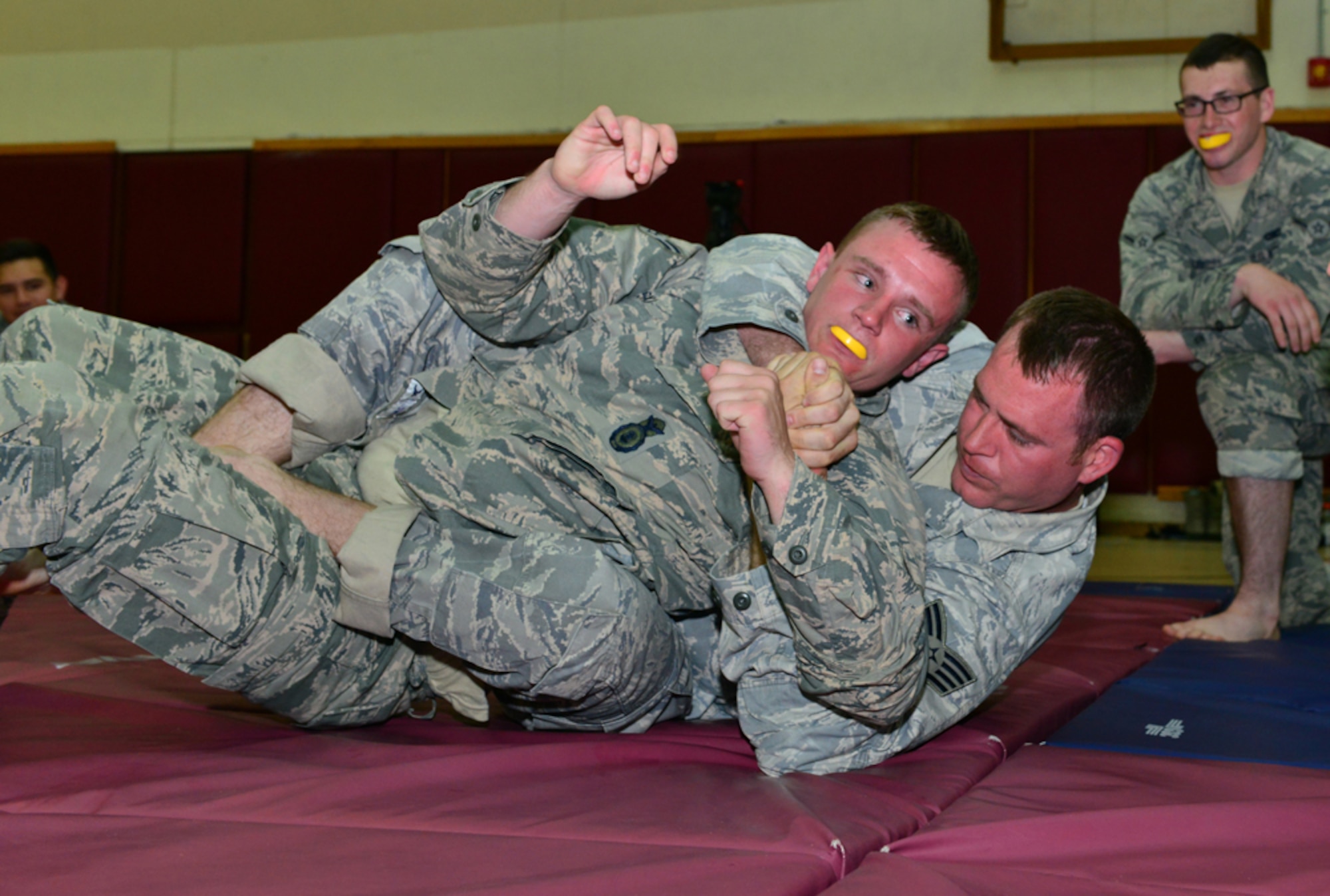 Members from the 39th Security Forces Squadron practice restraining techniques during a basic combat arms course April 21, 2015 at Incirlik Air Base, Turkey.  As part of the week-long course, defenders learned movement techniques, evasive grappling, weapons control and suspect detainment. (U.S. Air Force photo by Senior Airman Michael Battles/Released) 