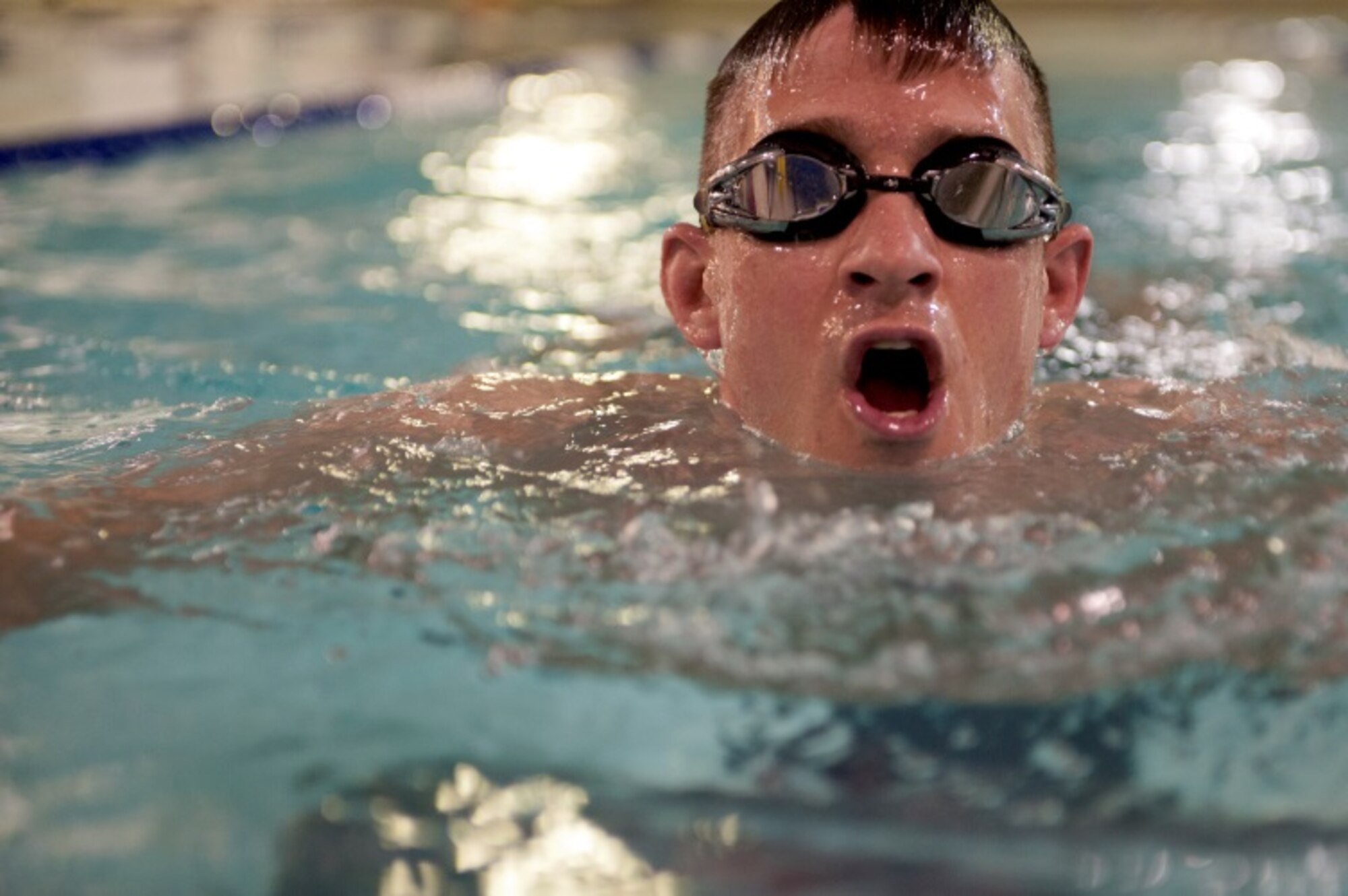 Capt. Craig Gilman, a member of the 5th Operation Support Squadron, comes up for breath after finishing a lap in the McAdoo Fitness Center on Minot Air Force Base, N.D., April 24, 2015. Thanks to the new expanded hours, people can enjoy a morning swim before work. (U.S. Air Force photo/Airman 1st Class Christian Sullivan)
