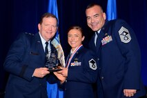 Maj. Gen. Richard Scobee (left), 10th Air Force commander, and Chief Master Sgt. Thomas Brandhuber (right), 10th Air Force command chief, pose for a photo with the 10th Air Force's Outstanding SNCO of the Year winner, Master Sgt. Brianne Forrester, (center), from the 919th Special Operations Force Support Squadron, during the Air Force Reserve Command banquet at the Waverly Hotel in Atlanta, Ga., April 15, 2015. The AFRC banquet honored Citizen Airmen for their hard work and dedication. (U.S. Air Force photo/Brad Fallin)
