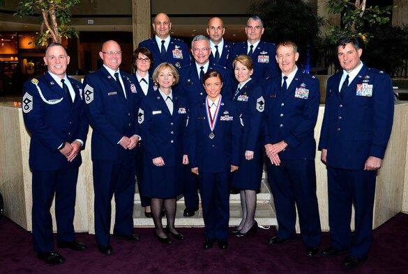 919th Special Operations Wing leadership pose for a photo with the 10th Air Force  Outstanding SNCO of the Year winner Master Sgt. Brianne Forrester (center), from the 919th Special Operations Force Support Squadron, during the Air Force Reserve Command banquet at the Waverly Hotel in Atlanta, Ga., April 15, 2015. The AFRC banquet honored Citizen Airmen for their hard work and dedication. (U.S. Air Force photo/Brad Fallin)