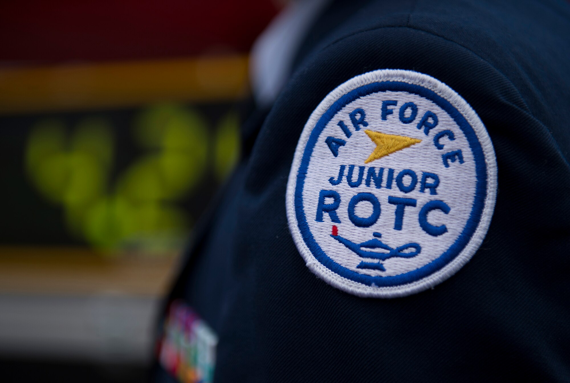 A member of the Bitburg Middle High School Junior Reserve Officer Training Corps displays his patch during a JROTC 5K run at Spangdahlem Air Base, Germany, April 25, 2015 . The JROTC is a federal program sponsored by the United States Armed Forces in high schools across America and U.S. military installations across the world. (U.S. Air Force photo by Airman 1st Class Luke Kitterman/Released)
