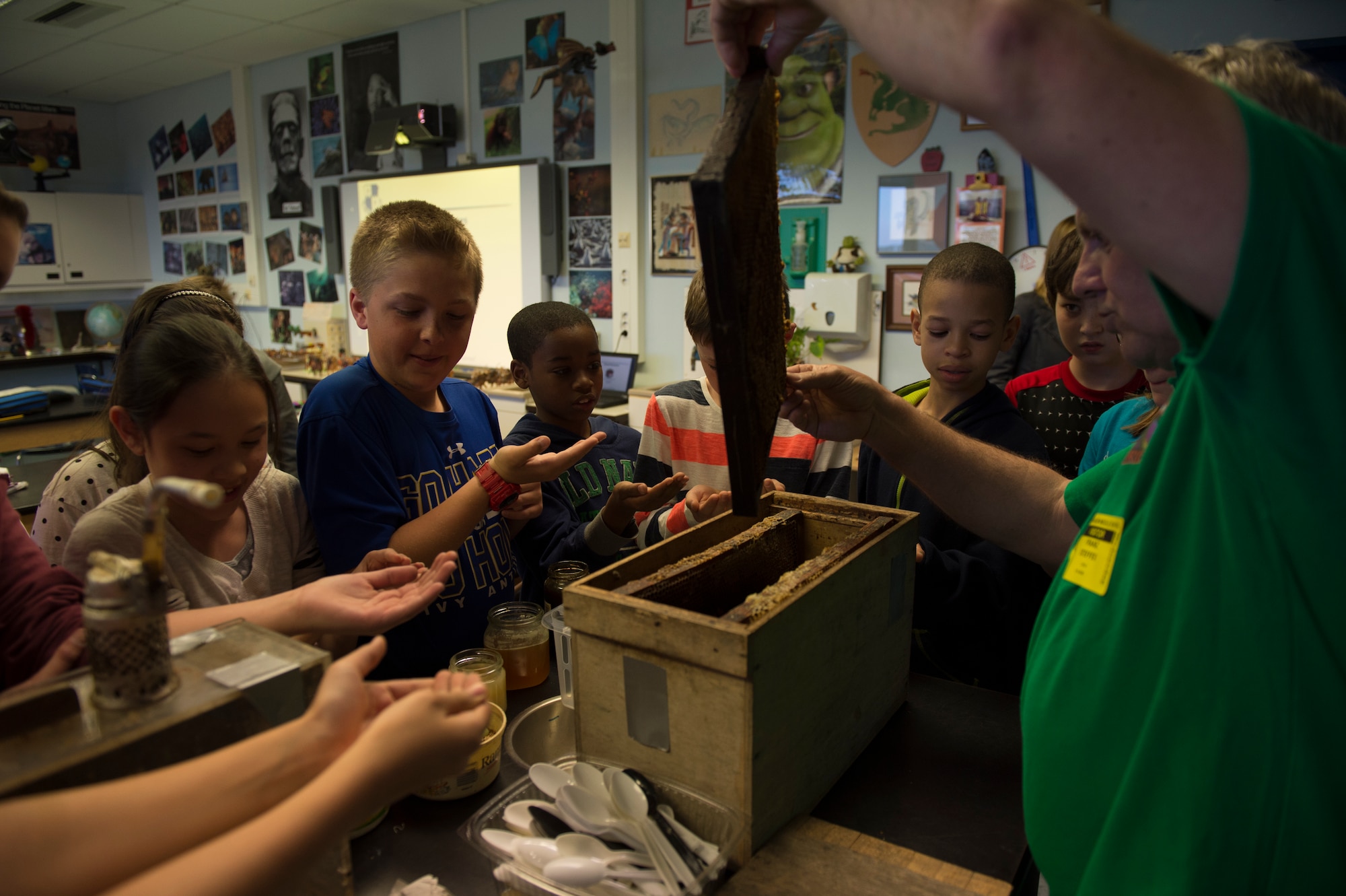 Franz Steffes, 52nd Civil Engineer Squadron conservation program manager, displays a honey comb tray of a European Honey Bee to Spangdahlem Middle School students during an Earth Day classroom presentation at Spangdahlem Air Base, Germany, April 22, 2015.  Earth Day is observed worldwide to promote the environment and spread awareness of the dangers harming it. (U.S. Air Force photo by Staff Sgt. Christopher Ruano/Released)