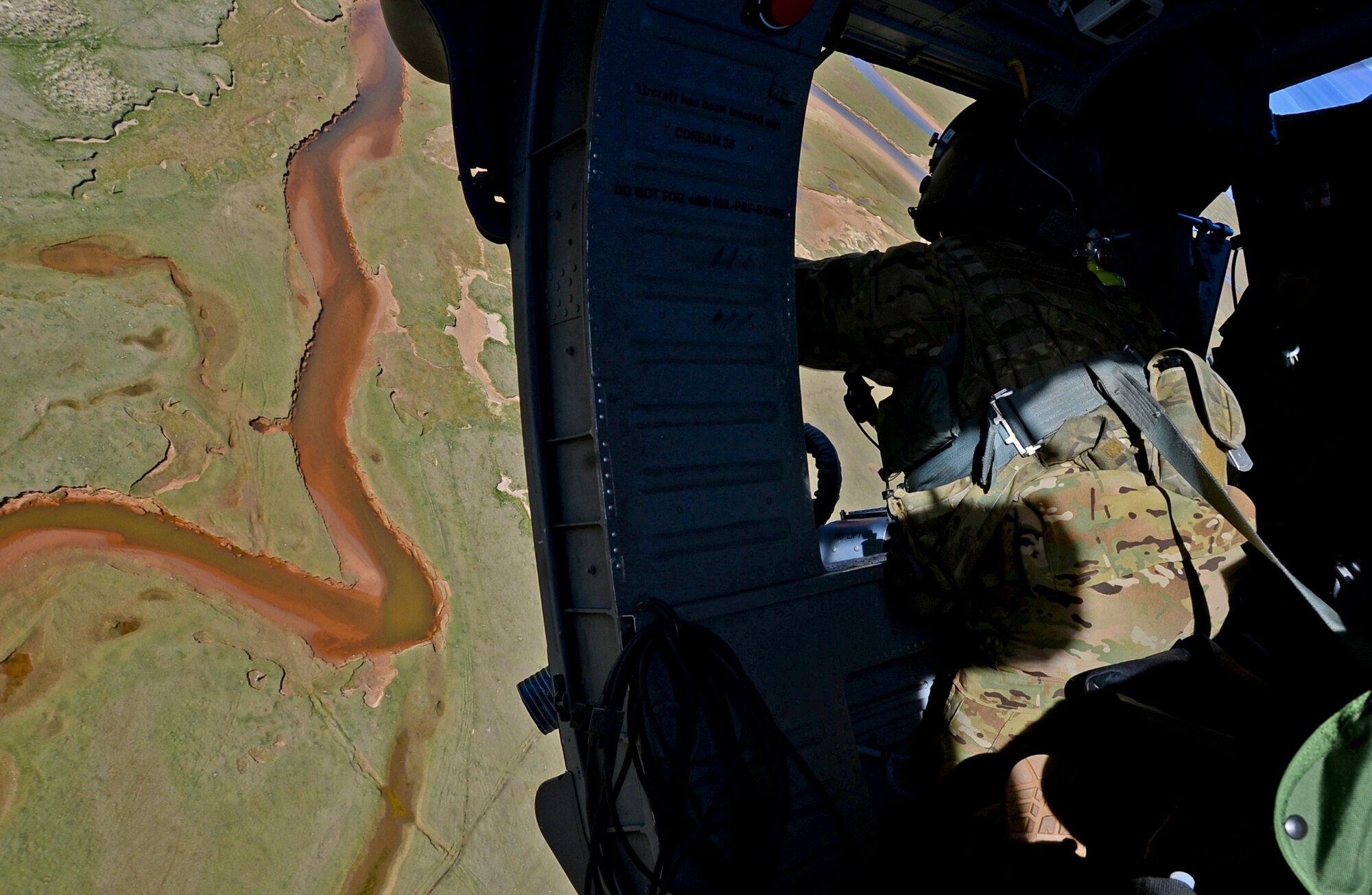 A special missions aviator assigned to Royal Air Force Lakenheath's 56th Rescue Squadron prepares to fire a .50-caliber machine gun from an HH-60G Pave Hawk helicopter during exercise Joint Warrior 15-1 in Scotland, April 22, 2015. The training helped aircrew sharpen their skills so they will be ready for real-world operations. (U.S. Air Force photo by Senior Airman Erin O'Shea/Released)