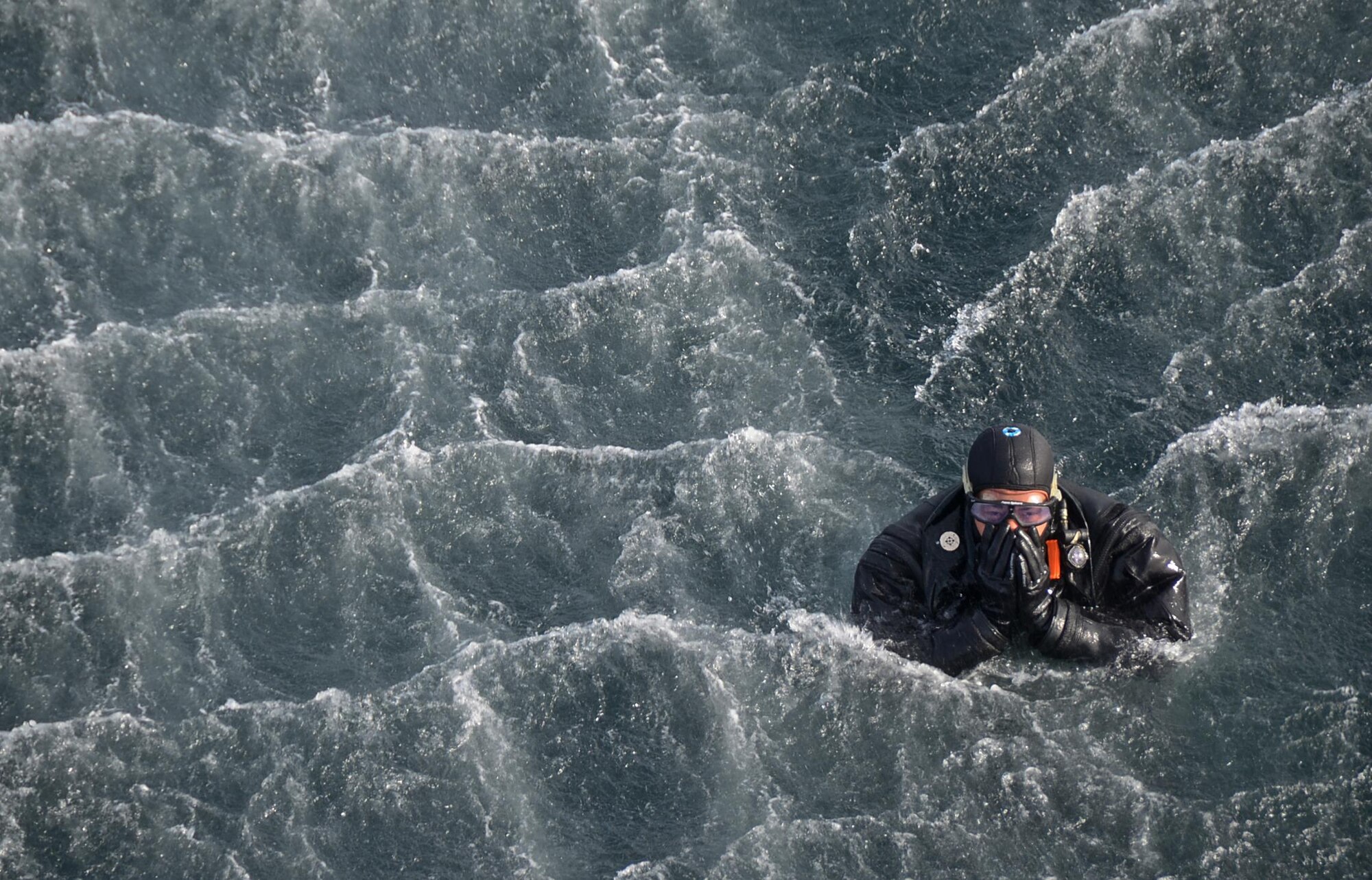 A pararescueman assigned to Royal Air Force Lakenheath's 57th Rescue Squadron prepares to be hoisted into an HH-60G Pave Hawk helicopter during exercise Joint Warrior 15-1 in Scotland, April 22, 2015. Three 56th RQS Pave Hawks participated in the multinational training where they practiced air-to-air combat maneuvers over both land and sea. (U.S. Air Force photo by Senior Airman Erin O'Shea/Released)