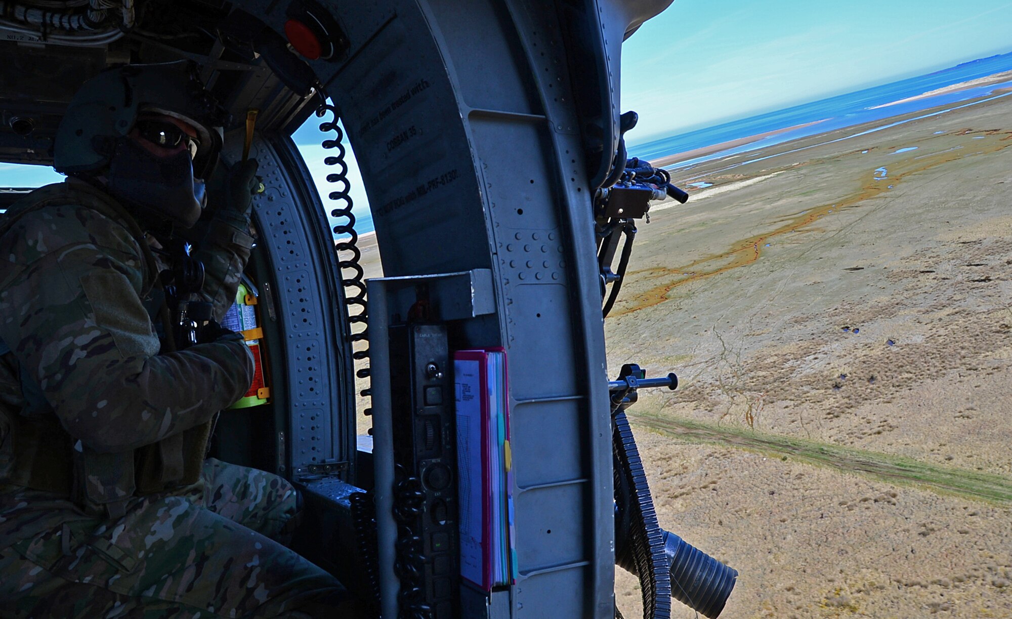 A special missions aviator assigned to Royal Air Force Lakenheath's 56th Rescue Squadron prepares to fire a .50-caliber machine gun on an HH-60G Pave Hawk helicopter during training exercise Joint Warrior 15-1 in Scotland, April 22, 2015. The training helps aircrew maintain their skills and enables them to quickly react and perform during real-world scenarios. (U.S. Air Force photo by Senior Airman Erin O'Shea/Released)