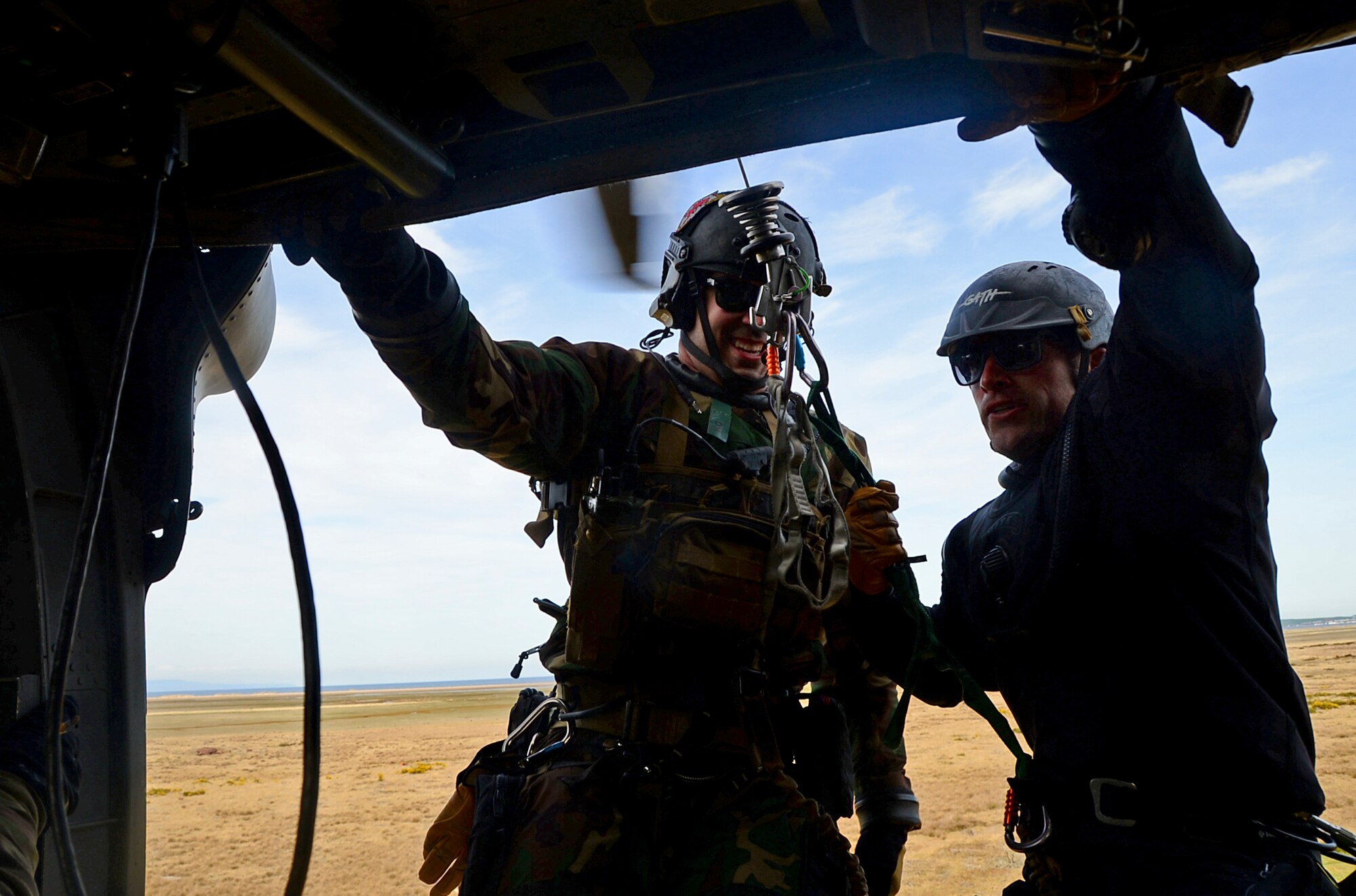 Pararescuemen assigned to Royal Air Force Lakenheath's 57th Rescue Squadron enter an HH-60G Pave Hawk during exercise Joint Warrior 15-1 in Scotland, April 22, 2015. Airmen assigned to the 56th and 57th Rescue Squadrons participated in the multinational exercise to increase their readiness capabilities. (U.S. Air Force photo by Senior Airman Erin O'Shea/Released)