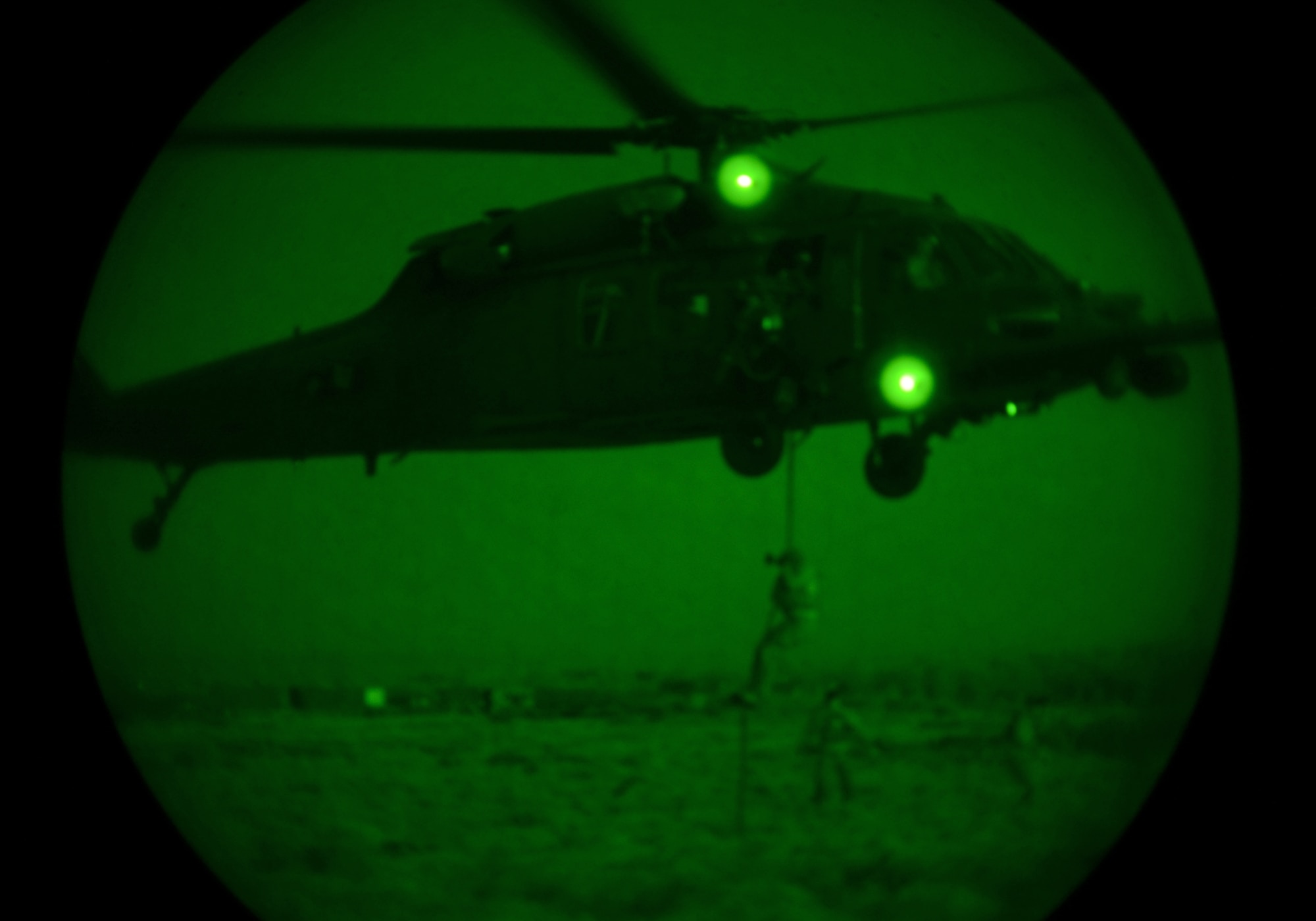 Pararescuemen assigned to Royal Air Forces Lakenheath's 57th Rescue Squadron rappel from an HH-60G Pave Hawk during an evening training mission at exercise Joint Warrior 15-1 in Scotland, April 22, 2015. The exercise enhanced the 56th RQS's capability to support real-world operations, as well as provided an opportunity to train with NATO allies. (U.S. Air Force photo by Senior Airman Erin O'Shea/Released) 