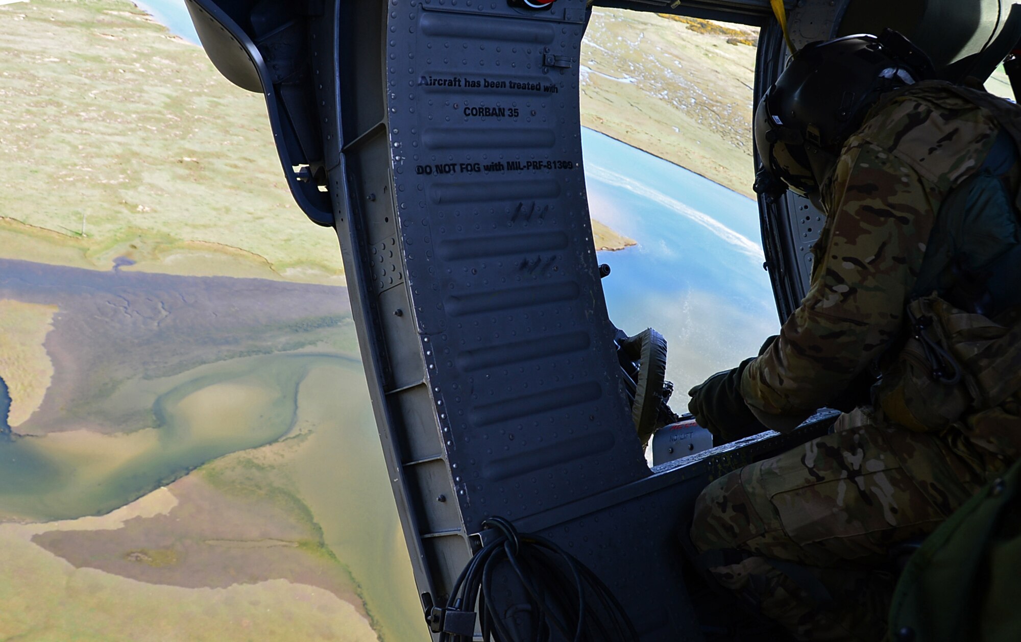A special missions aviator assigned to Royal Air Force Lakenheath's 56th Rescue Squadron prepares to fire a .50-caliber machine gun out of an HH-60G Pave Hawk helicopter during exercise Joint Warrior 15-1 in Scotland, April 22, 2015. Airmen assigned to the 56th and 57th Rescue Squadron participated in the multinational exercise to increase their readiness capabilities. (U.S. Air Force photo by Senior Airman Erin O'Shea/Released) 