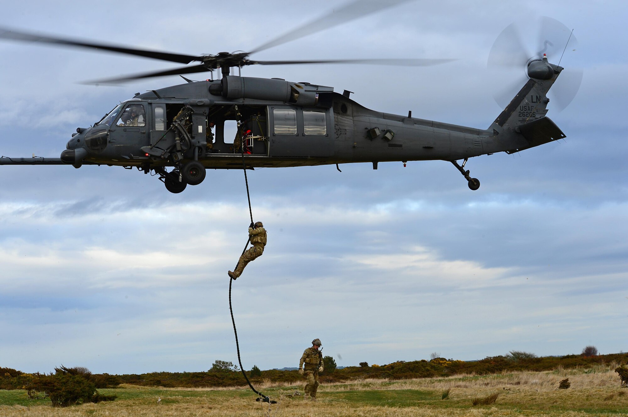 Pararescuemen assigned to Royal Air Force Lakenheath's 57th Rescue Squadron rappel from an HH-60G Pave Hawk in multinational exercise Joint Warrior 15-1 in Scotland, April 21, 2015. About 13,000 personnel from 14 countries participated in the exercise, to strengthen and test their readiness capabilities. (U.S. Air Force photo by Senior Airman Erin O'Shea/Released)