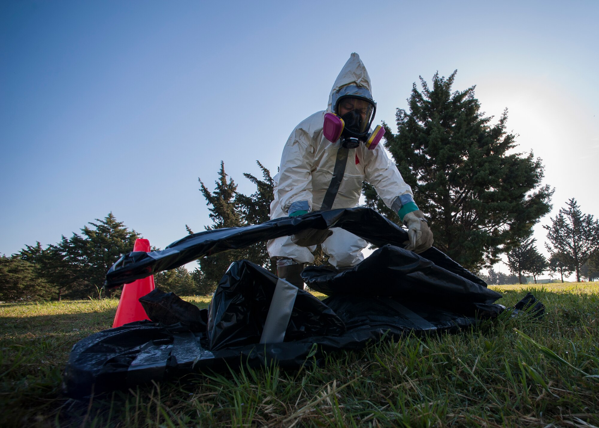 Senior Airman Lindsey Scaggs, 39th Maintenance Squadron crash recovery team member, places a piece of debris in a pile during a composite material handling training April 15, 2015 at Incirlik Air Base, Turkey. There were four pieces of debris that were sprayed, wrapped and removed from the simulated crash site during the training. (U.S. Air Force photo by Airman 1st Class Cory W. Bush/Released)
