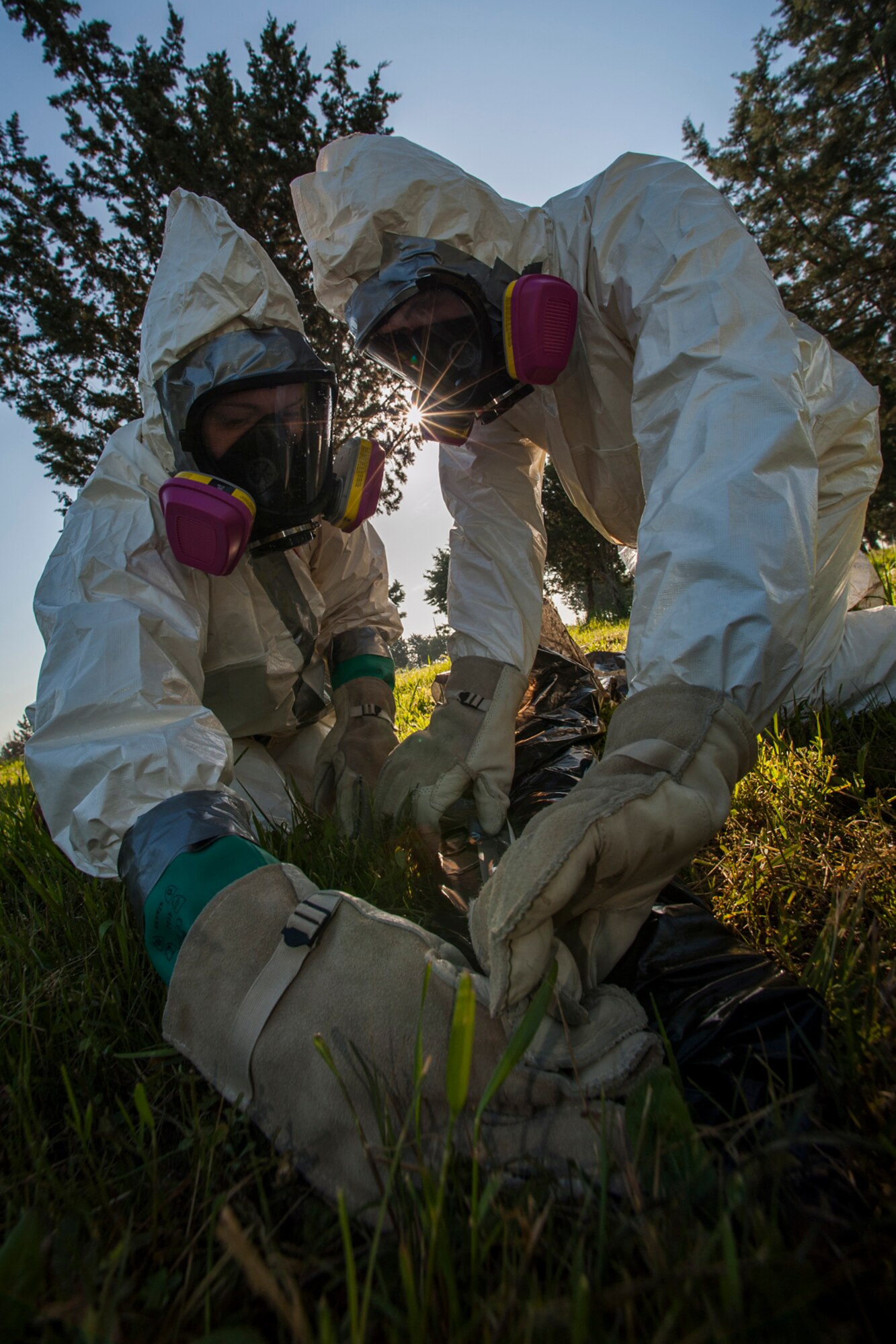 Senior Airman Lindsey Scaggs (left), and Staff Sgt. Michael Marquart, 39th Maintenance Squadron crash recovery team members, wrap a piece of debris with plastic during a composite material handling training April 15, 2015 at Incirlik Air Base, Turkey. The Airmen wrapped the debris in plastic for better handling by other agencies that receive the debris once it’s cleared from the crash site. (U.S. Air Force photo by Airman 1st Class Cory W. Bush/Released)