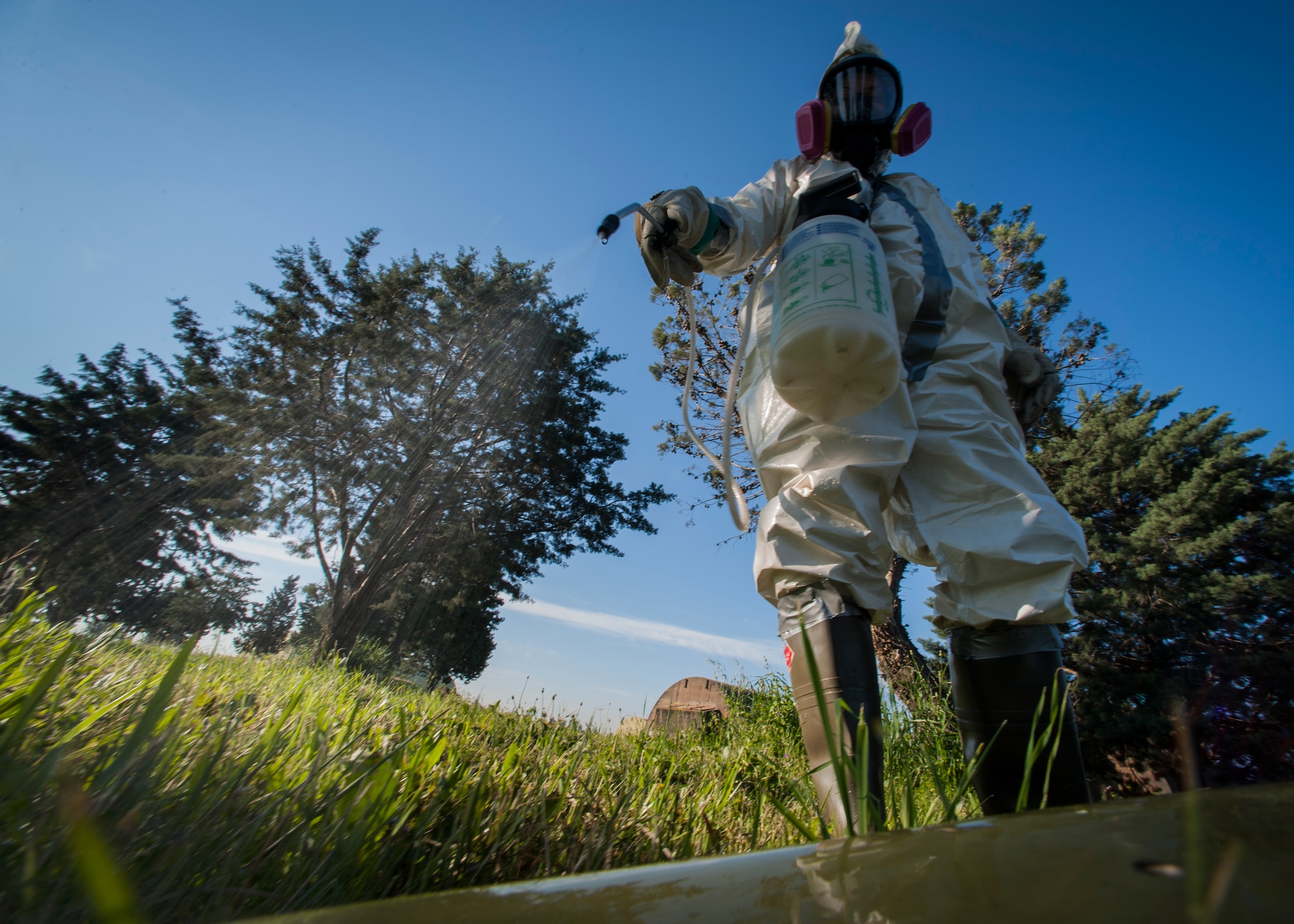 Senior Airman Lindsey Scaggs, 39th Maintenance Squadron crash recovery team member, sprays a piece of aircraft debris during a composite material handling training April 15, 2015 at Incirlik Air Base, Turkey. The debris was coated with a formula similar to common floor wax to make it safer to handle. (U.S. Air Force photo by Airman 1st Class Cory W. Bush/Released)
