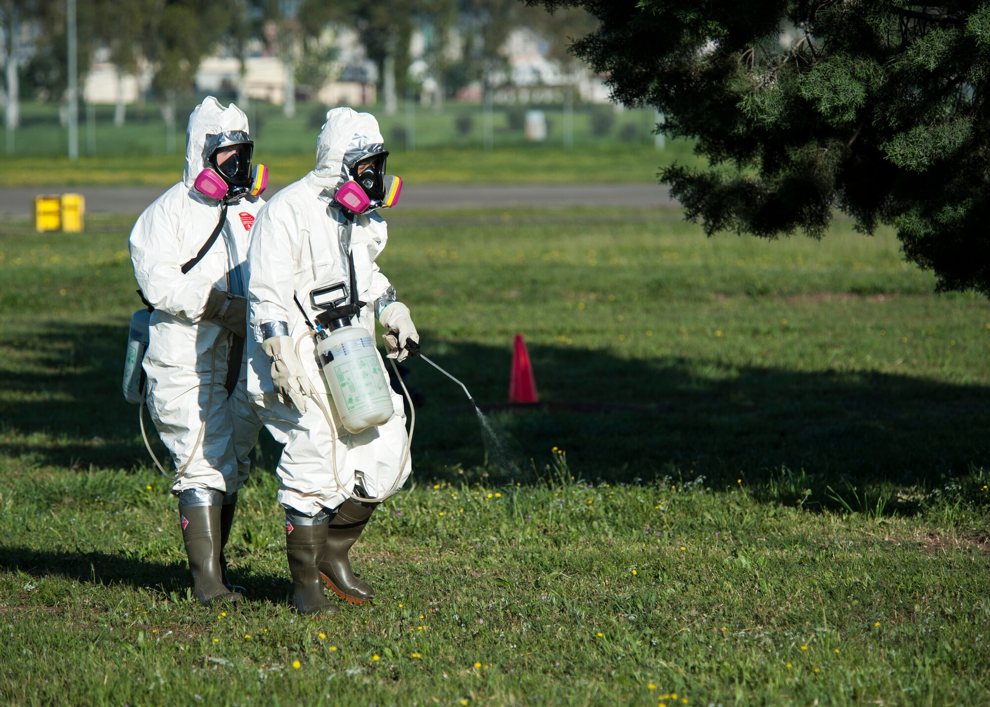 Senior Airman Lindsey Scaggs (left), and Staff Sgt. James Thammavongsa, 39th Maintenance Squadron crash recovery team members, spray for fibers during a composite material handling training April 15, 2015 at Incirlik Air Base, Turkey. The formula used to spray is similar to common floor wax; which weighs down the hazardous airborne fibers making it safe for other agencies to access the area. (U.S. Air Force photo by Airman 1st Class Cory W. Bush/Released)