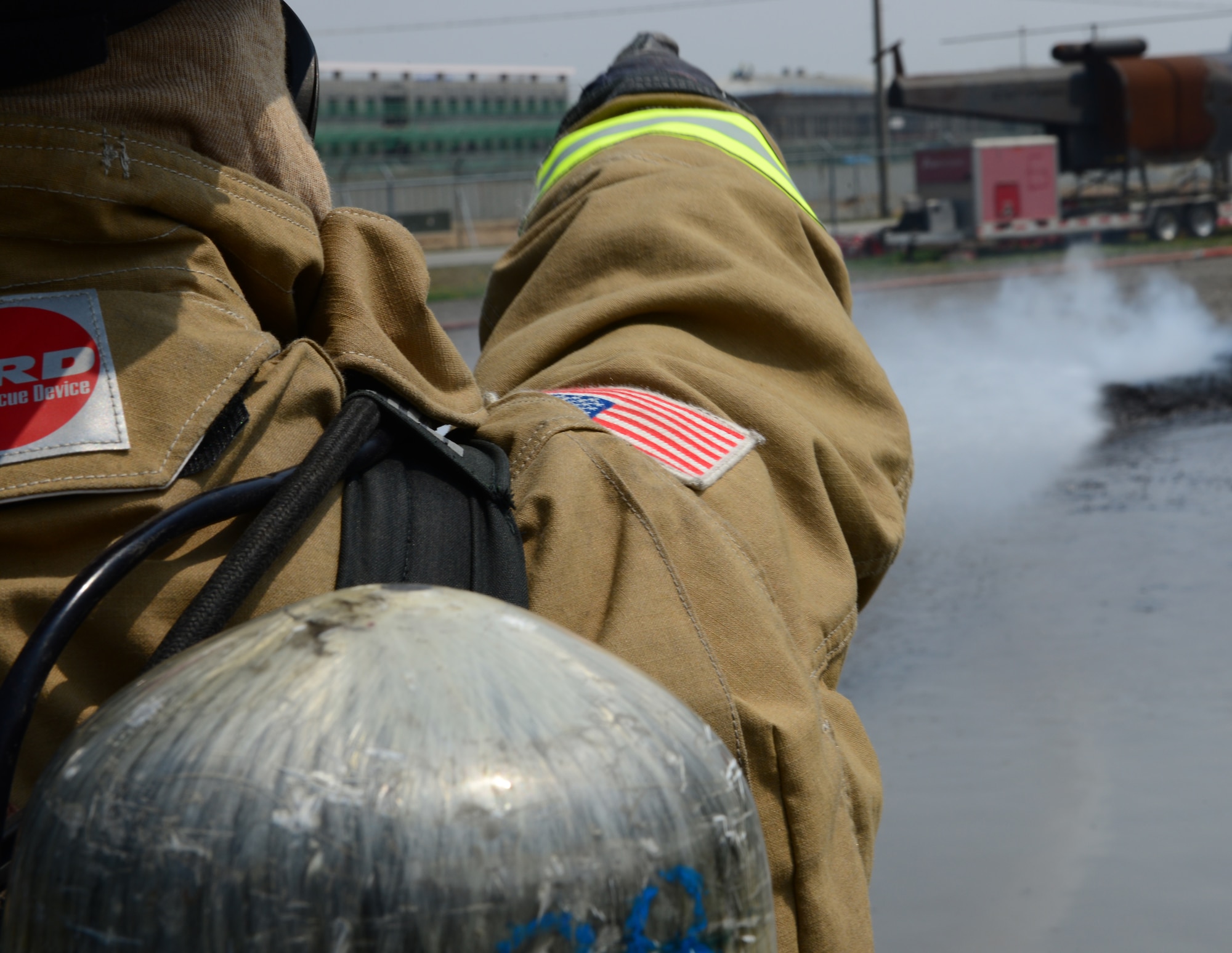 A firefighter from Osan Air Base, Republic of Korea, points to a still burning fire inside the fire pit during training April 22, 2015, at the U.S. Army Garrison Humphreys', ROK. The training, hosted by firefighters from Humphreys' assisted the Osan firefighters with annual training requirements necessary to maintain safety for the more than 10,000 service members, dependents and civilians who reside in and around Osan AB. (U.S. Air Force photo by Staff Sgt. Benjamin Sutton/Released)