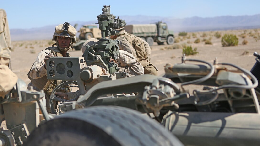 Marine Cpl. Osmar S. Gorish, a section chief for Battery A, 1st Battalion, 11th Marine Regiment, 1st Marine Division, supervises as his section adjusts the azimuth on their M777 155mm Howitzer during Exercise Desert Scimitar 2015 at Marine Corps Air Ground Combat Center Twentynine Palms, Calif., April 20, 2015.