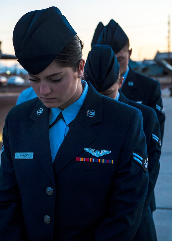 U.S. airmen bow their heads during a prayer at the Australia and New Zealand Army Corps Day commemorative service on Holloman Air Force Base, N.M., April 25, 2015.