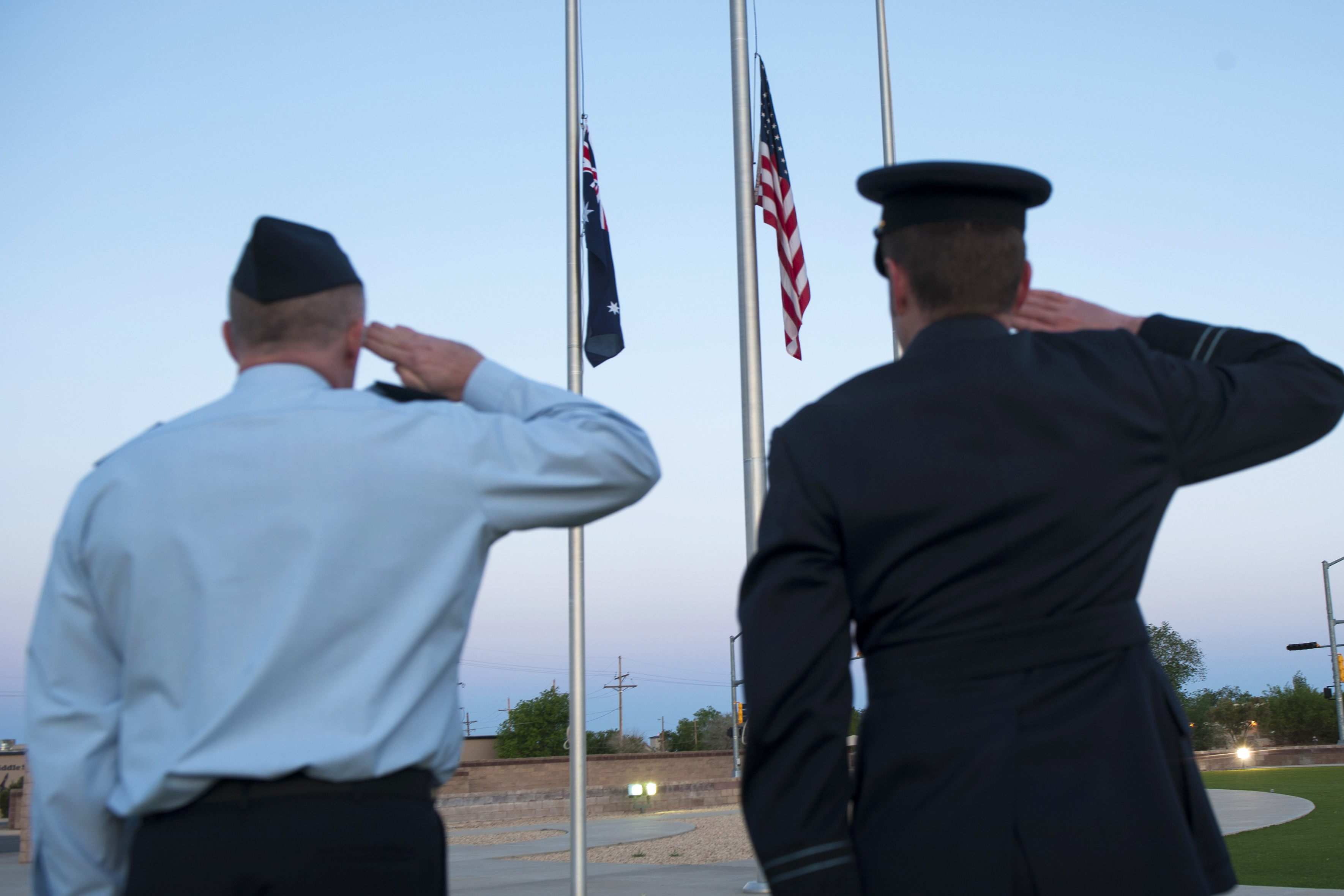 Members of the Royal Australian air force salute during reveille at the