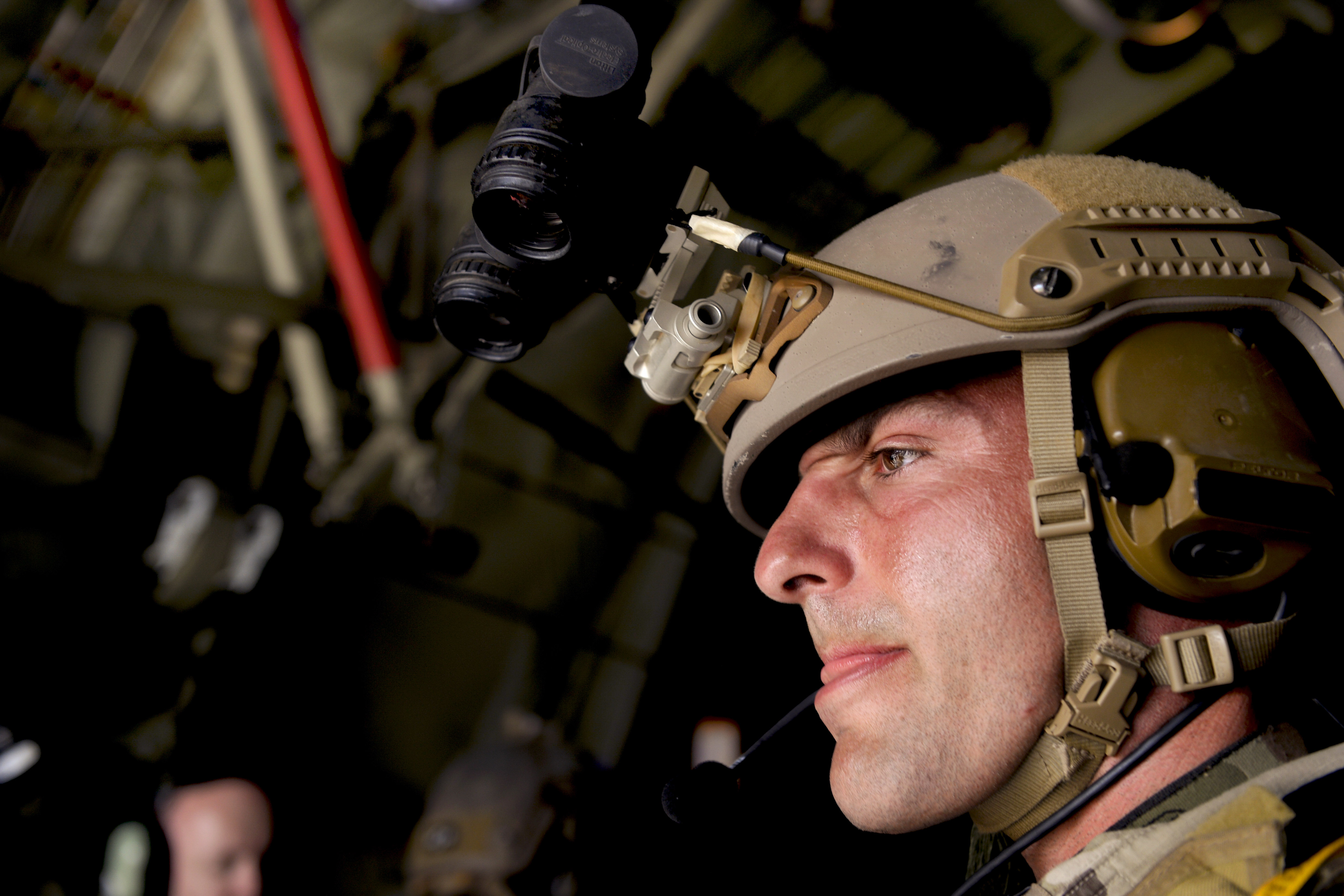A U.S. Special Forces soldier waits for a C-130H3 Hercules aircraft to  reach the correct