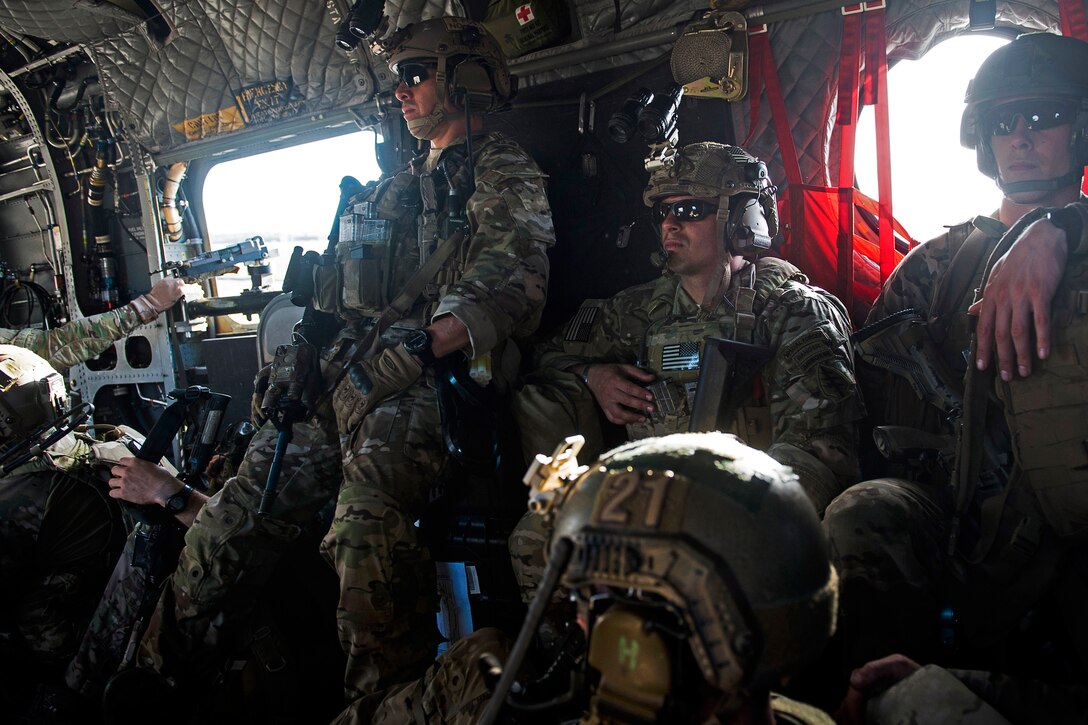 U.S. Special Forces soldiers ride in a CH-47 Chinook helicopter during ...