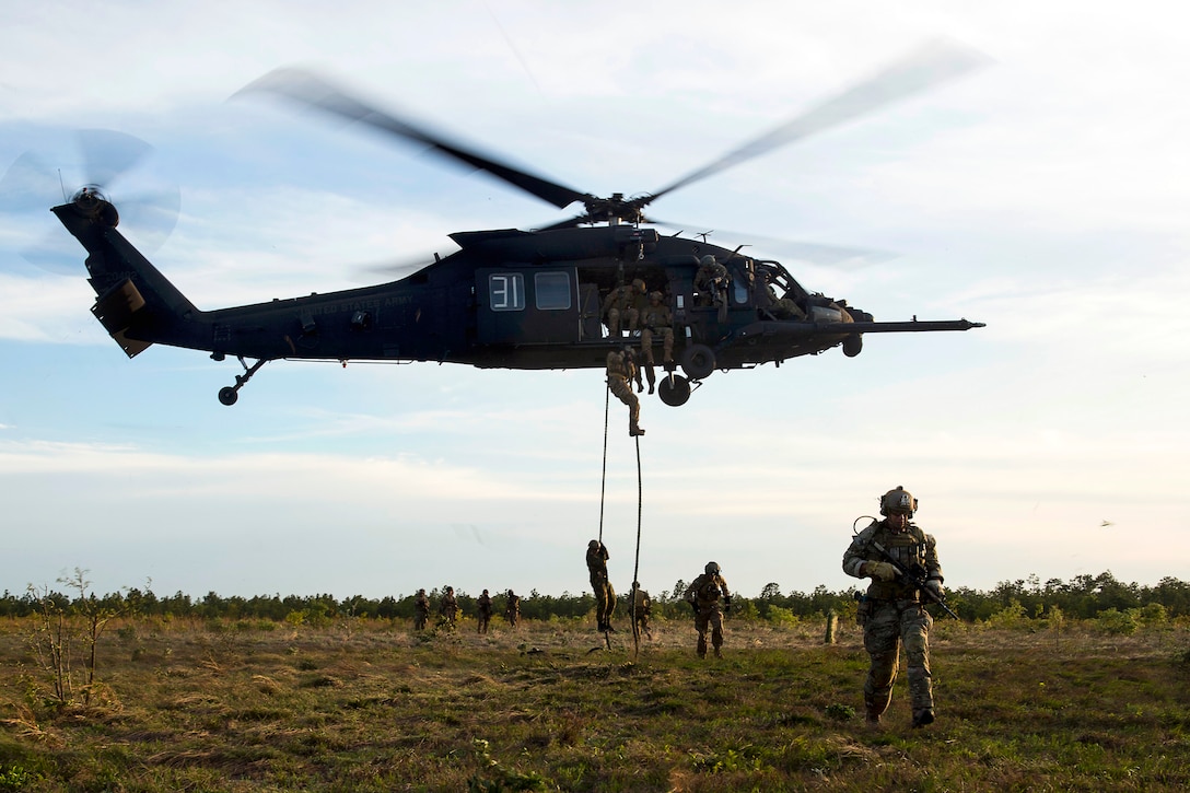 U.S. Special Forces soldiers exit a UH-60 Black Hawk helicopter during fast-rope insertion and extraction training as part of Emerald Warrior 2015 on Hurlburt Field, Fla., April 22, 2015.