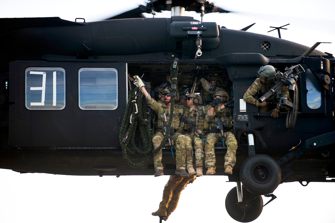 Us Special Forces Soldiers Prepare To Fast Rope Out Of A Uh 60 Black Hawk Helicopter During 