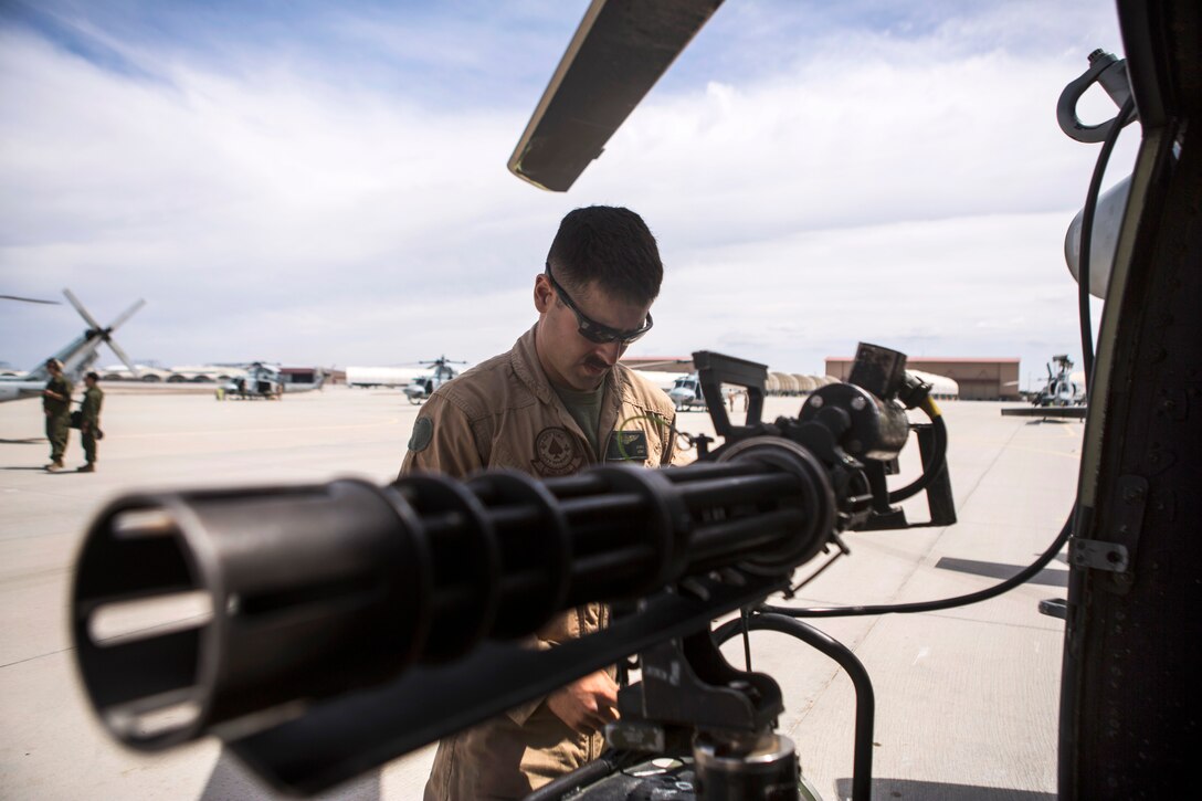 U.S. Marine Corps Sgt. Jessie T. James inspects a mini-gun before Final Exercise 3 during Weapons and Tactics Instructor Course 2-15 near Yuma, Ariz., April 25, 2015. James is a crew chief assigned to Marine Light Attack Helicopter Squadron 267.