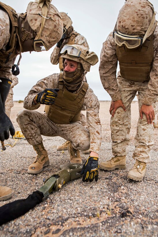 U.S. Marine Corps Lance Cpl. Alex M. Geyer, center, gives instruction before an external lift, part of Final Exercise 3 during the Weapons and Tactics Instructor Course 2-15 near Yuma, Ariz., April 25, 2015. Geyer is a landing support specialist assigned to Landing Support Company, 1st Transportation Support Battalion.