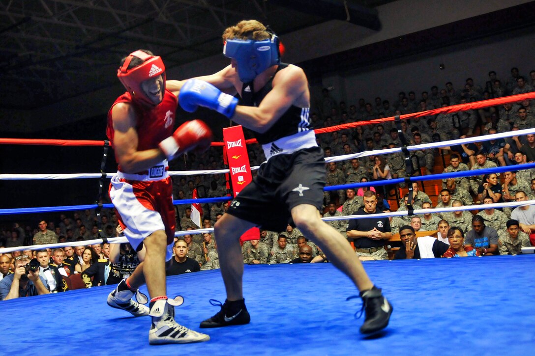U.S. Army Spc. Sandy Rivas, left, connects with a punch to British Pvt. Ben Swanbrik during the super featherweight fight of the Sicily Cup Competition of the International Paratrooper Brawl held at Ritz Epps Gym on Fort Bragg, N.C., April 23, 2015. Rivas is a paratrooper assigned to the 82nd Airborne Division's 1st Battalion, 325th Airborne Infantry Regiment, 2nd Brigade Combat Team and Swanbrik is a paratrooper assigned to the British 3rd Battalion Parachute Regiment.
