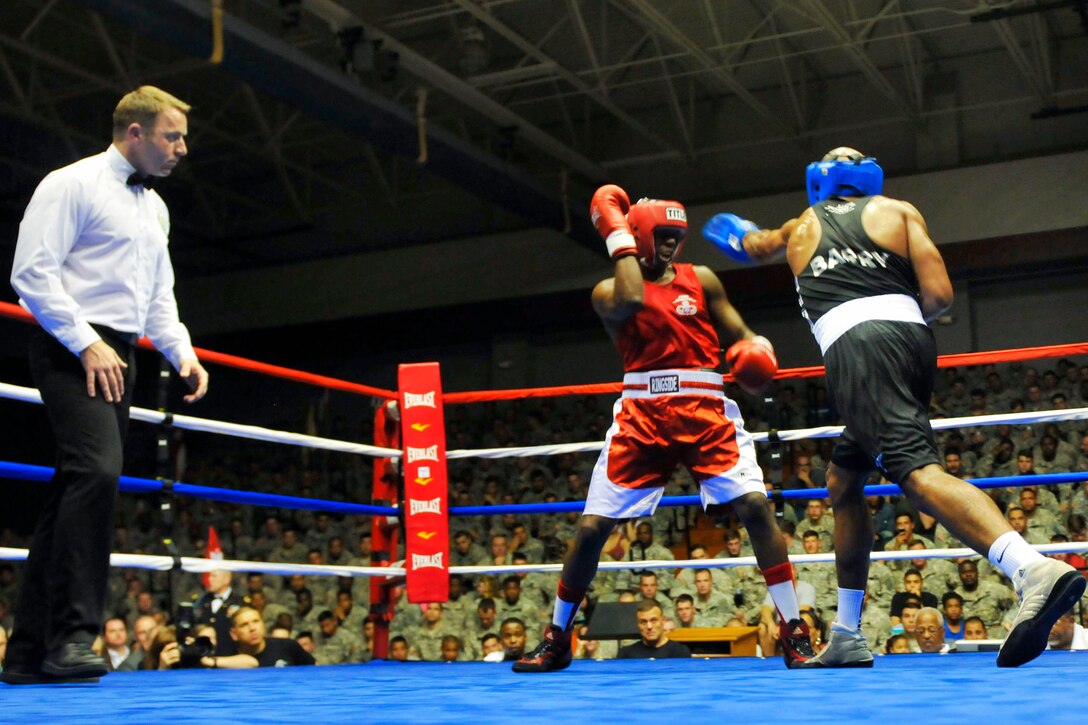 British Pvt. Tom Barry, right, delivers a punch to U.S. Army Cpl. James Kanal during a preliminary fight at the International Paratrooper Brawl held at Ritz Epps Gym on Fort Bragg, N.C., April 23, 2015. Barry is a paratrooper assigned to the British 3rd Battalion Parachute Regiment and Kanal is a paratrooper assigned to the 82nd Airborne Division.
