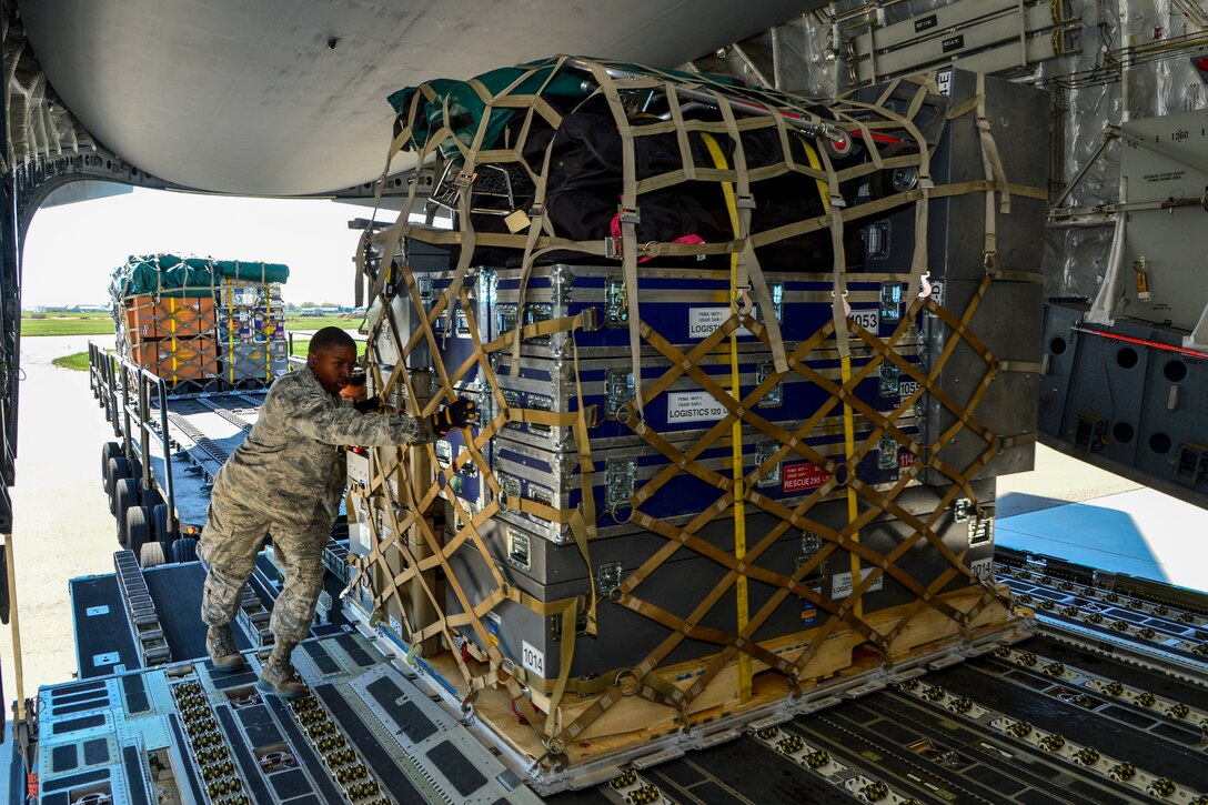 Air Force Senior Airman Tavin Alford loads equipment and supplies for the Fairfax County Urban Search and Rescue Team onto a C-17 Globemaster III on Dover Air Force Base, Del., April 26, 2015. Alford is an air transportation journeyman assigned to the 436th Aerial Port Squadron. 