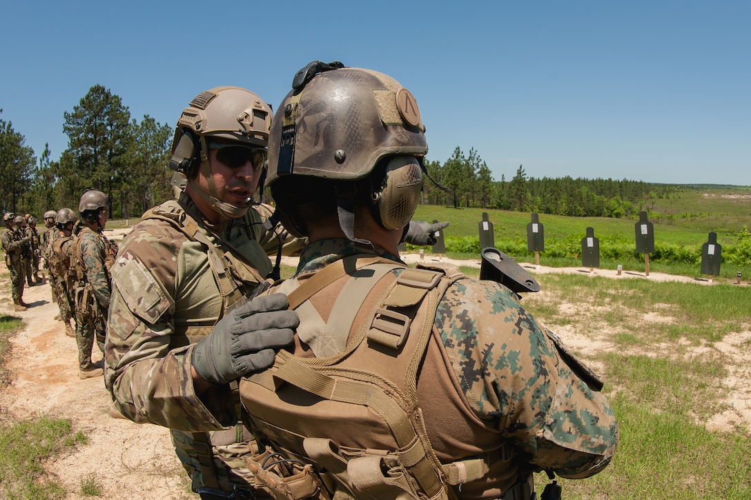 A U.S. Army National Guard special operations soldier assigns firing lanes to a Chilean counterpart  during a bilateral training exchange on Camp Shelby, Miss., April 21, 2015. The U.S. Army Special Operations Command South, supported by the Army National Guard and Special Operations Detachment South, organized a monthlong exchange to build strong and enduring partnerships with partner nation forces.